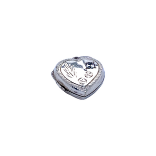 A Super Silver Heart Shaped Locket with Stone and lacy Etching on a white background.