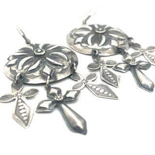 A pair of Super Silver handcrafted silver concho earrings with crosses on them, exuding southwest charm.