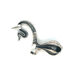 A Unique Cobra Ear Cuff in silver and black on a white surface from the brand Super Silver.