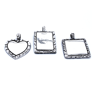Three customizable Super Silver Engravable Pendant With Cobblestone Border on a white background.