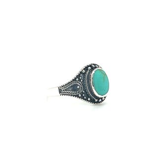 A Vintage Style Oval Shield Ring with Inlaid Stones with a turquoise stone.