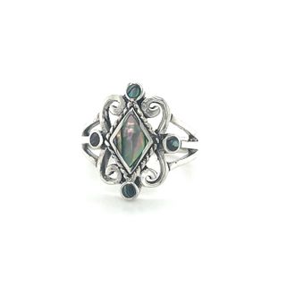 A Victorian style inlay ring with an inlay stone in the middle.