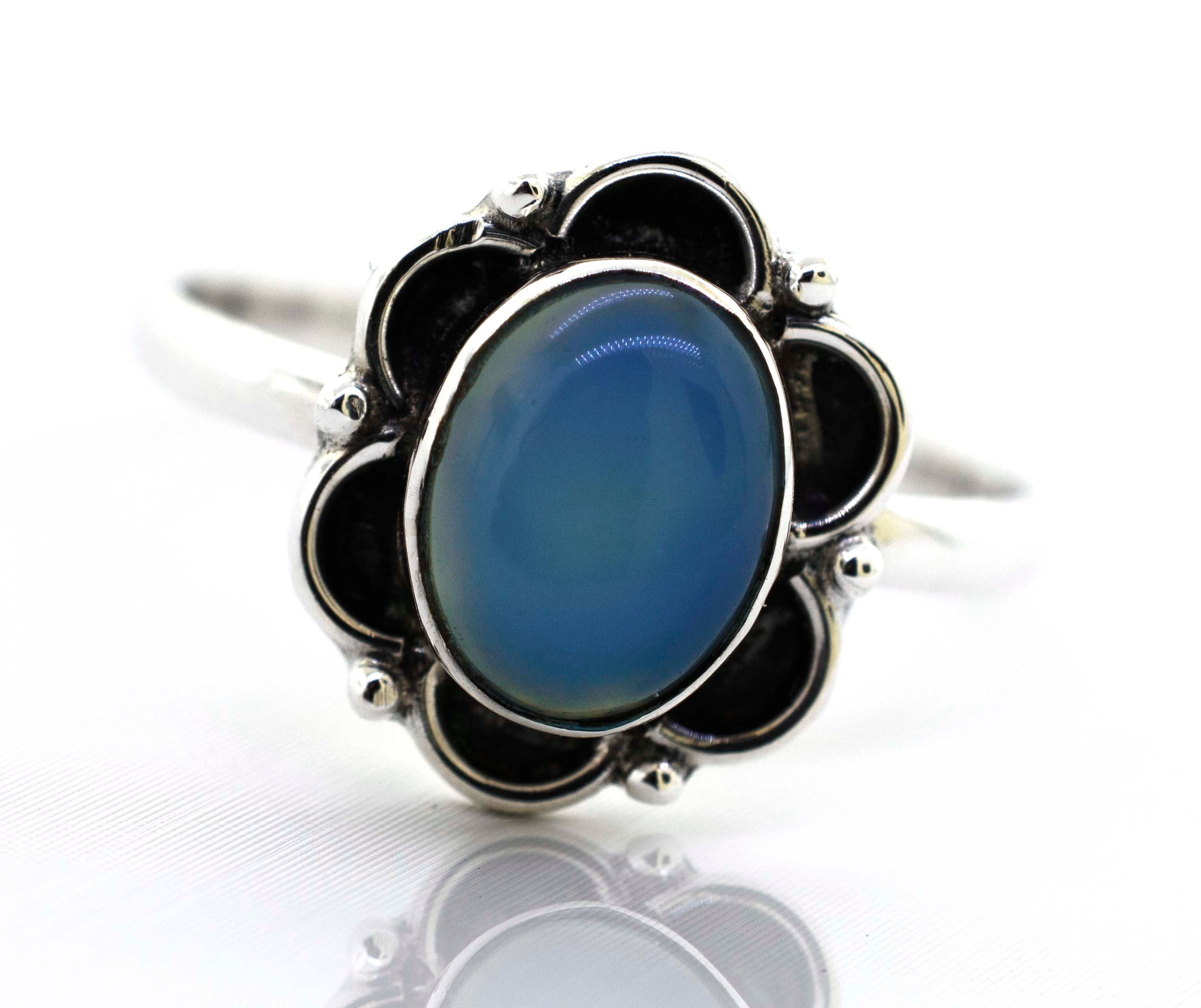 A delicate Super Silver gemstone ring with an oxidized flower design.