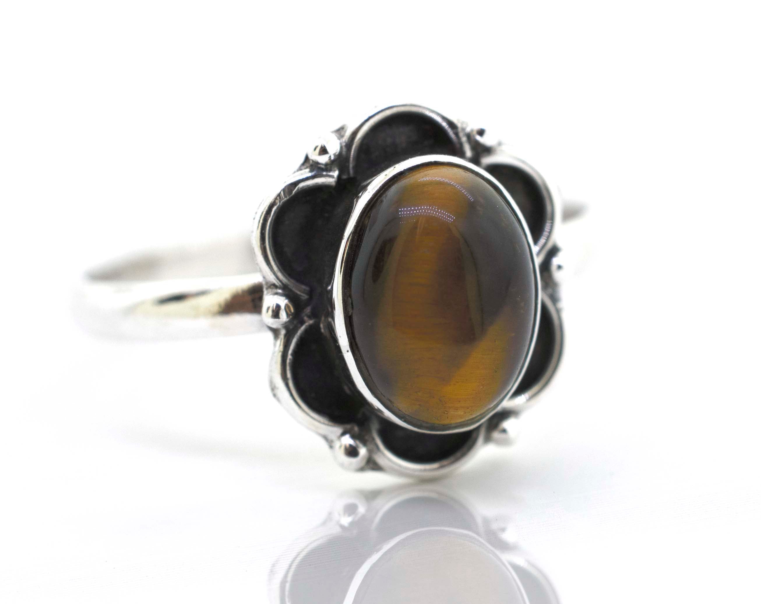A Super Silver Gemstone Ring With Oxidized Flower Design on a white background.