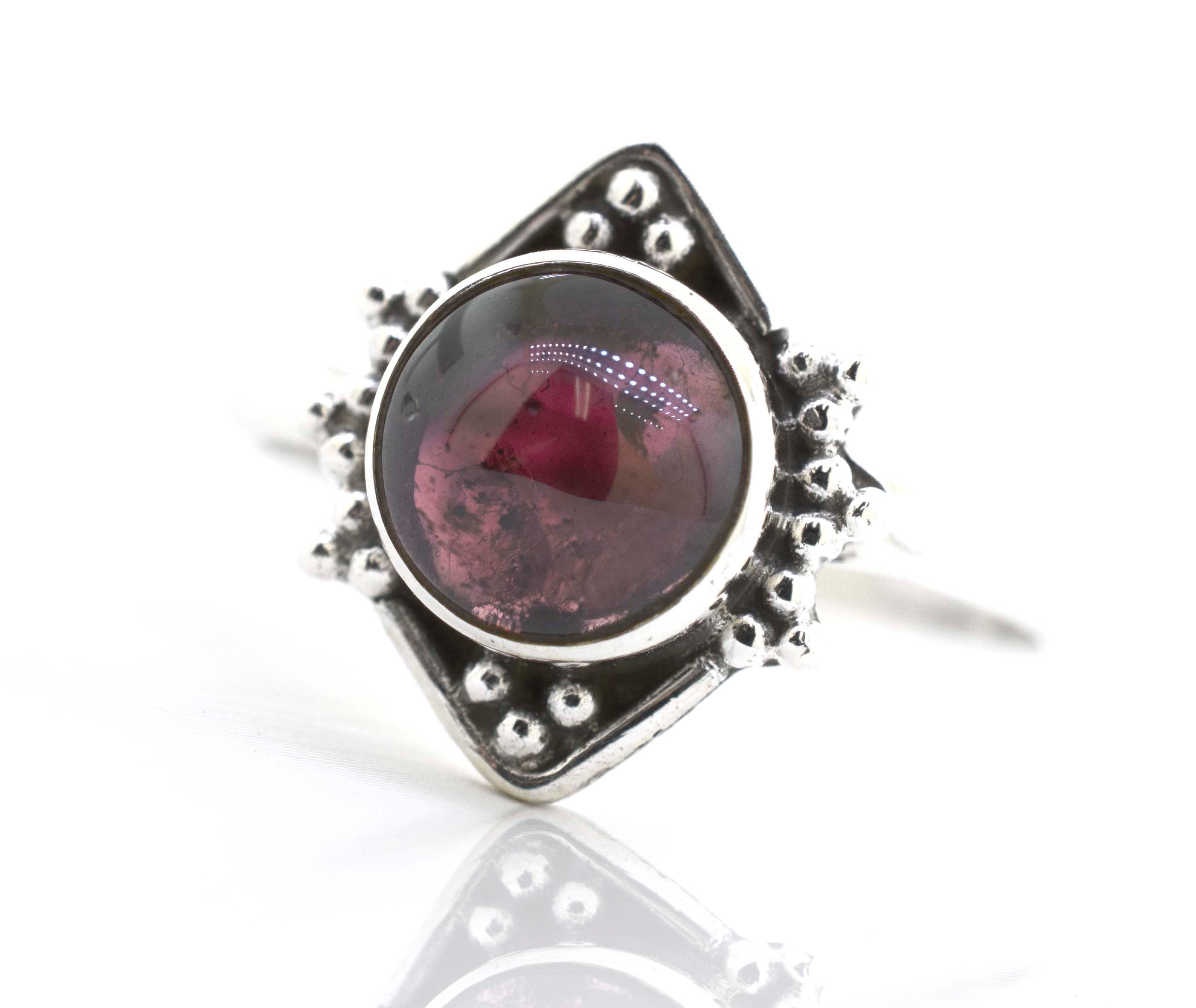 This Round Gemstone Ring With Oxidized Diamond Shape Pattern from Super Silver features a stunning red gemstone.