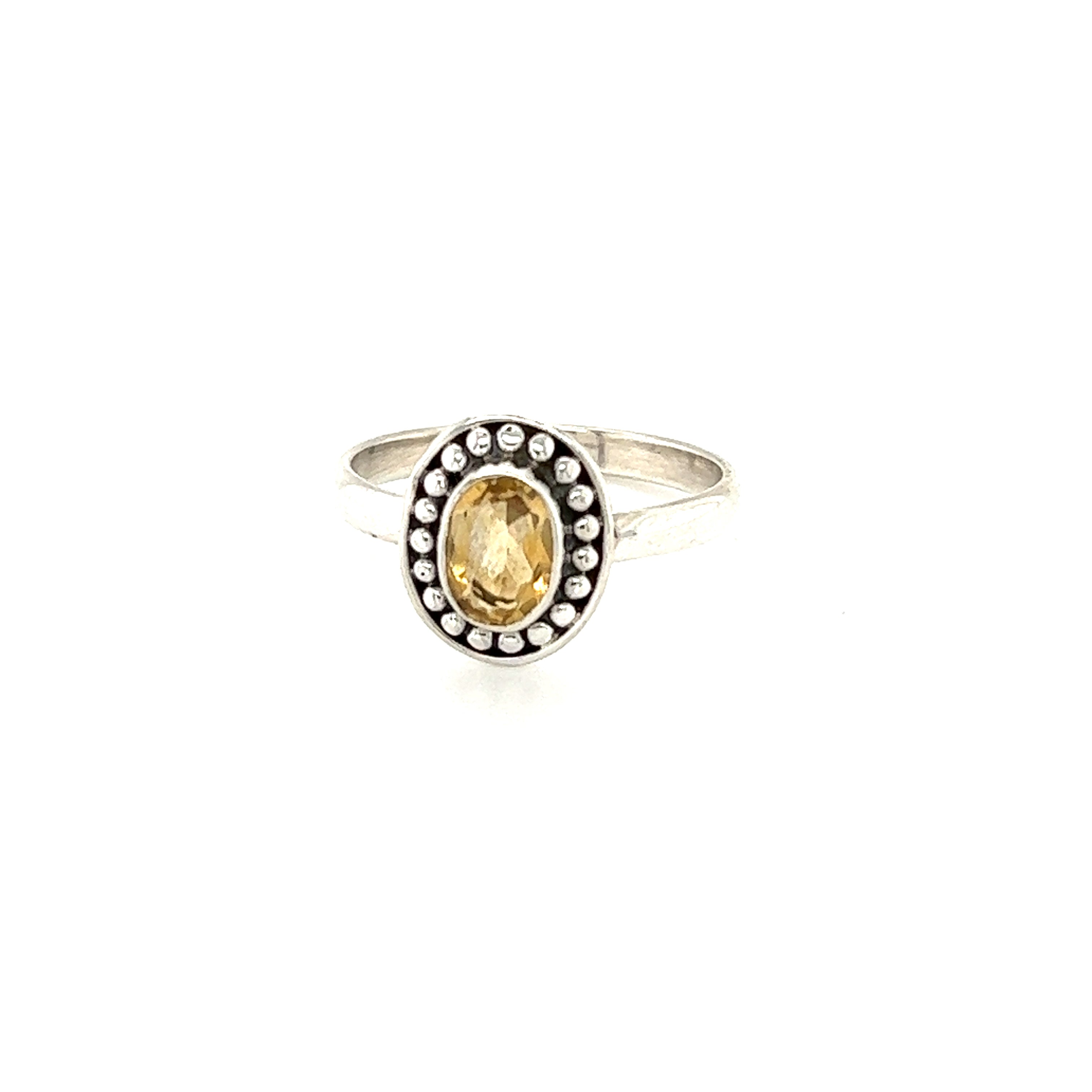 A Super Silver Oval Gemstone Ring with Ball Disk Border featuring an oval citrine stone and sparkling diamonds.