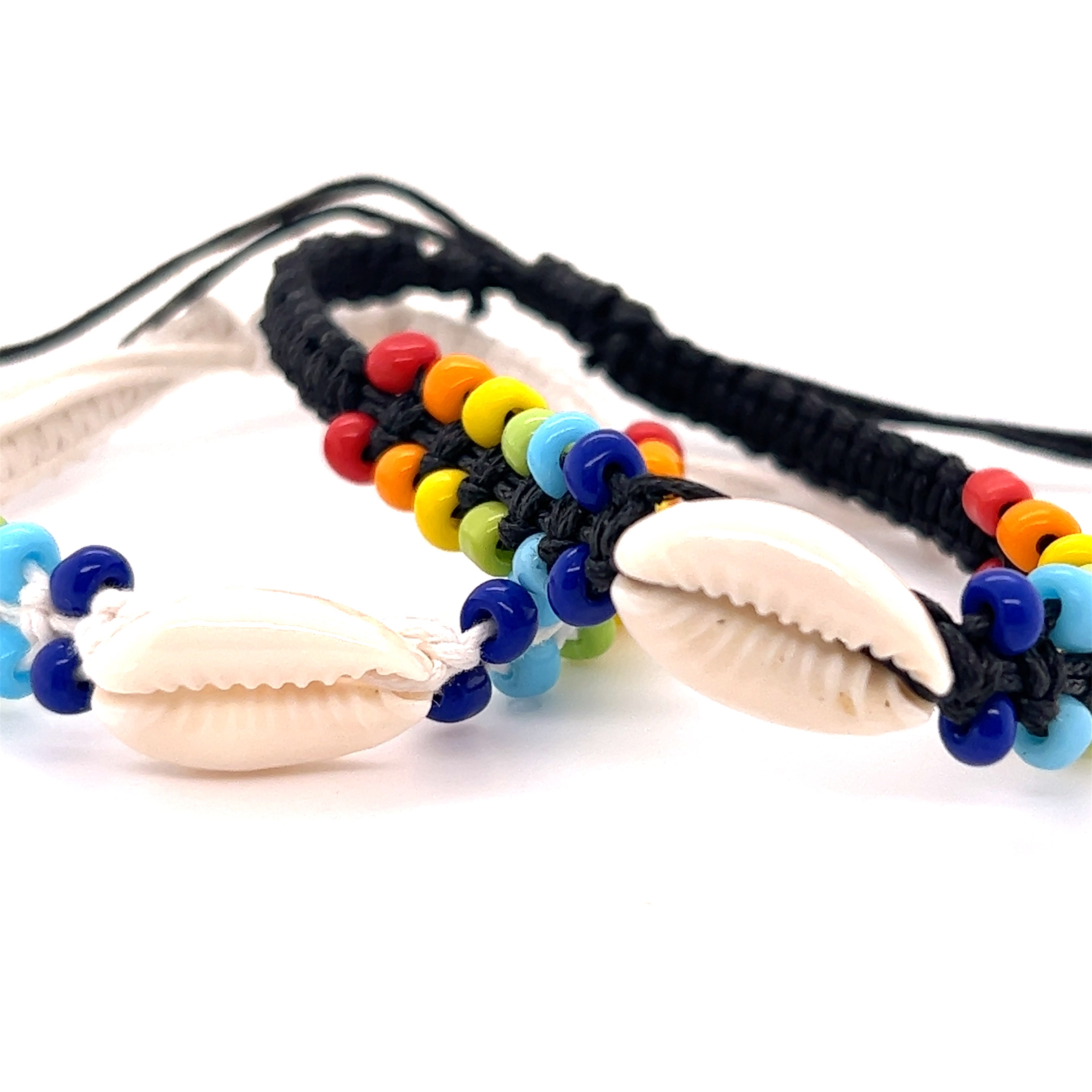 A pair of Super Silver Cowrie Shell Braided Bracelets with a coconut shell. These adjustable band accessories feature rainbow beads and include a Cowrie Shell Braided Bracelet for added style.