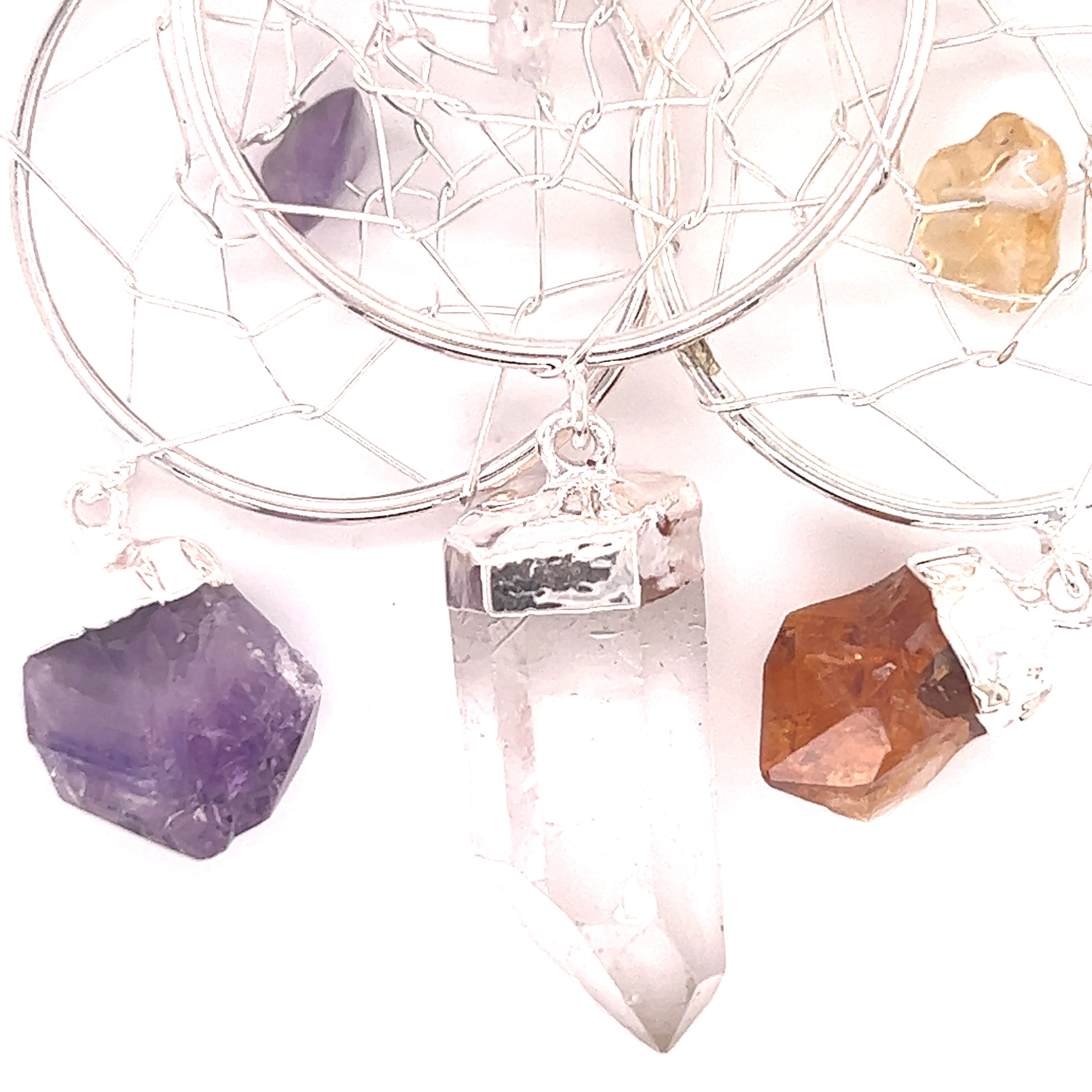 A Super Silver Dreamcatcher Pendant with Gemstone Point adorned with a raw crystal droplet and gemstones.