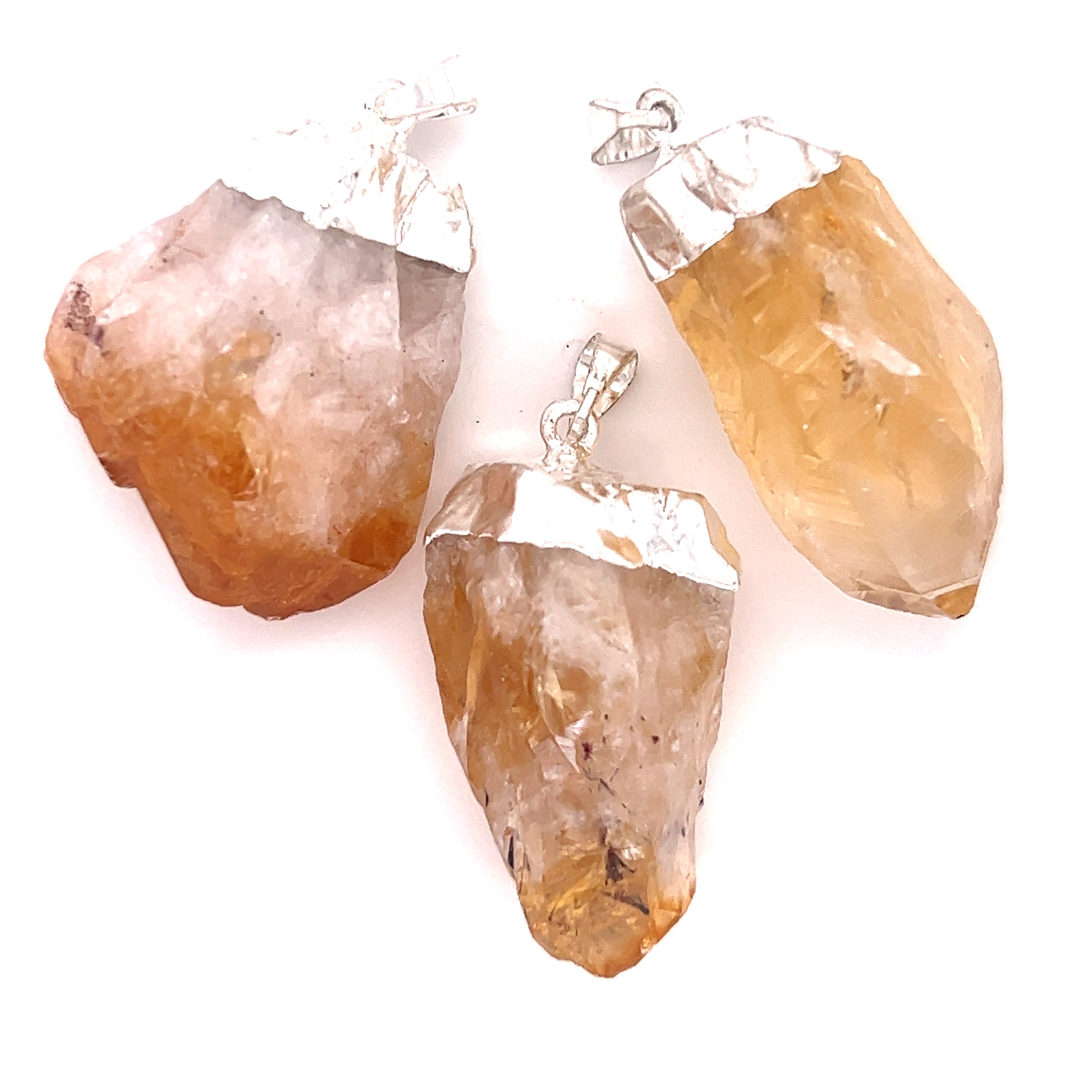 Three pieces of Super Silver's Raw Crystal Pendant With Silver Cap on a white background.