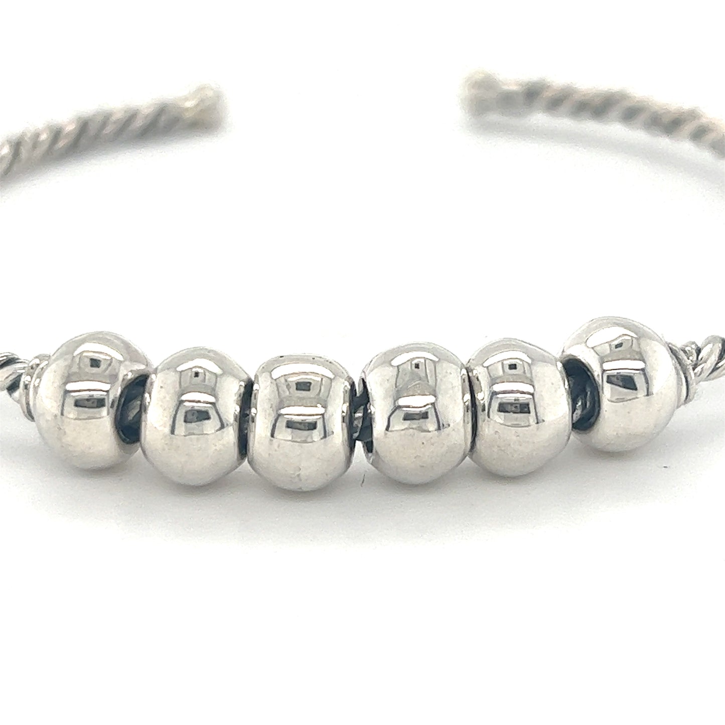 A Handmade Twisted Cuff with Balls by Super Silver adorned with four antique-look silver beads.