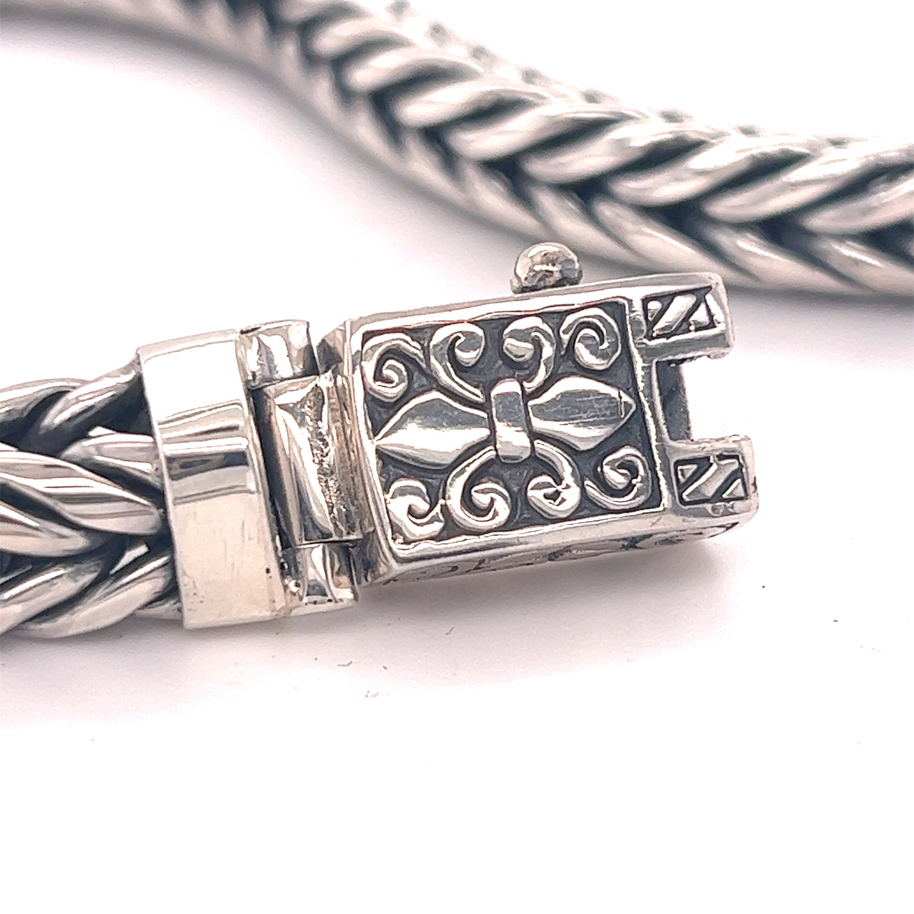 A Super Silver Heavy Braided Bracelet with an ornate clasp.