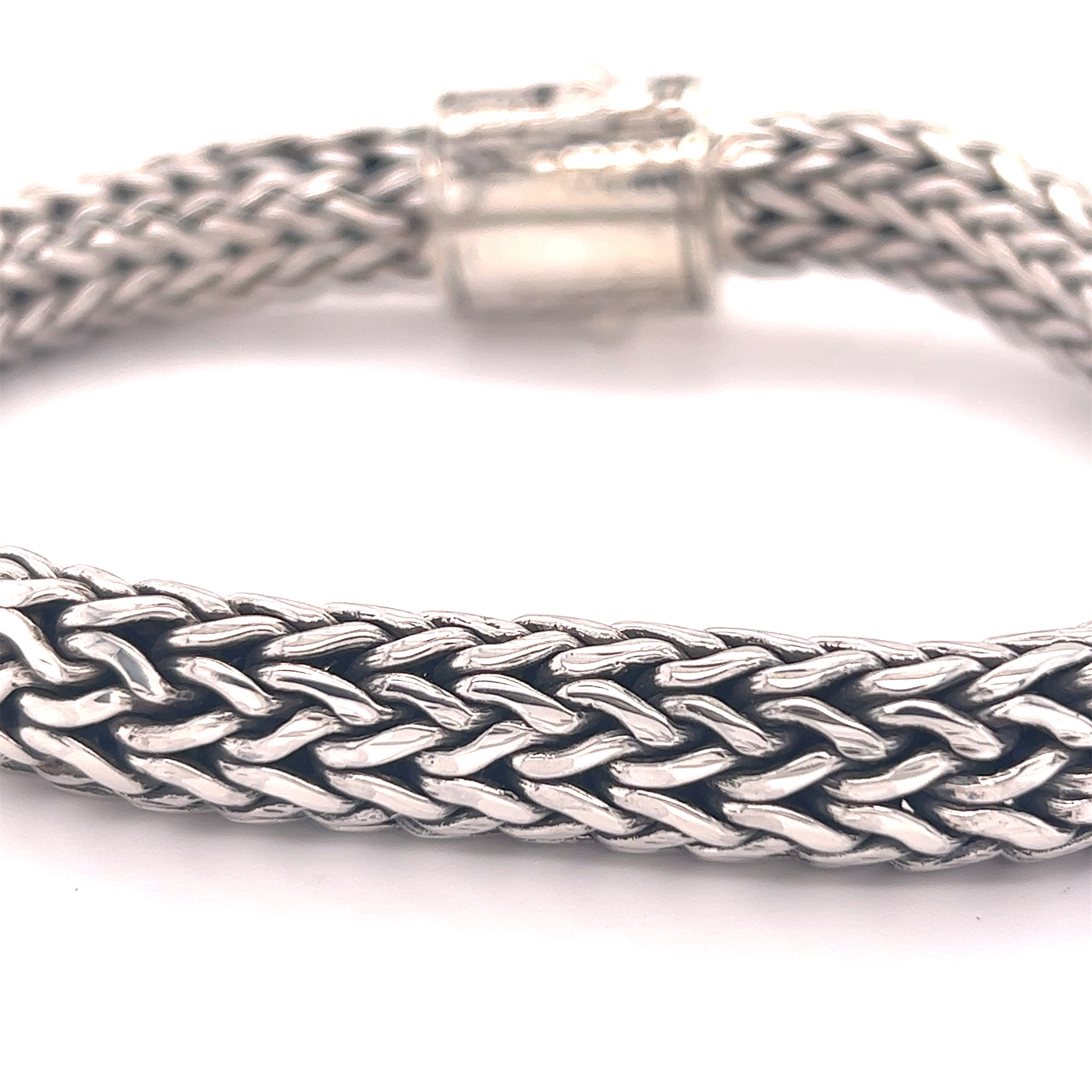 A Super Silver Heavy Braided Bracelet with a braided clasp.