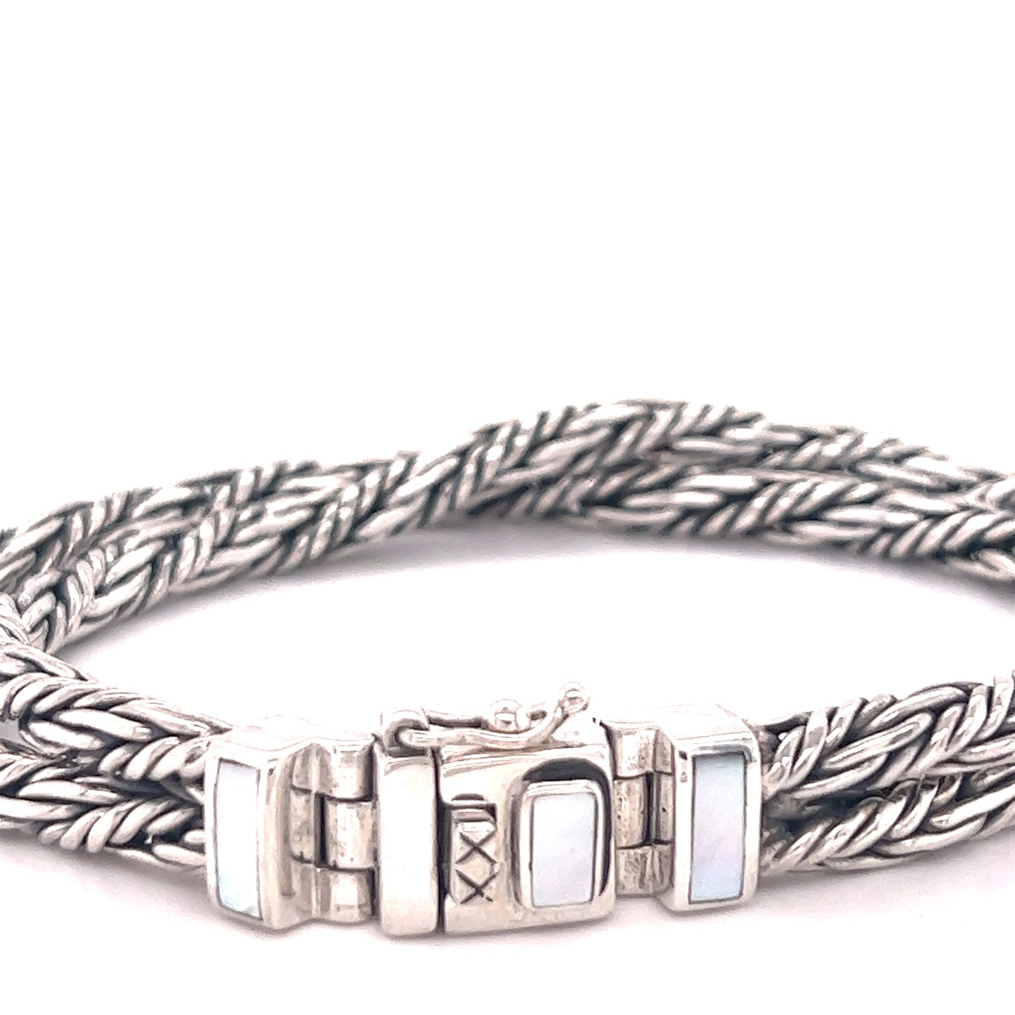 A Super Silver double twisted braided rope bracelet with a mother of pearl clasp.