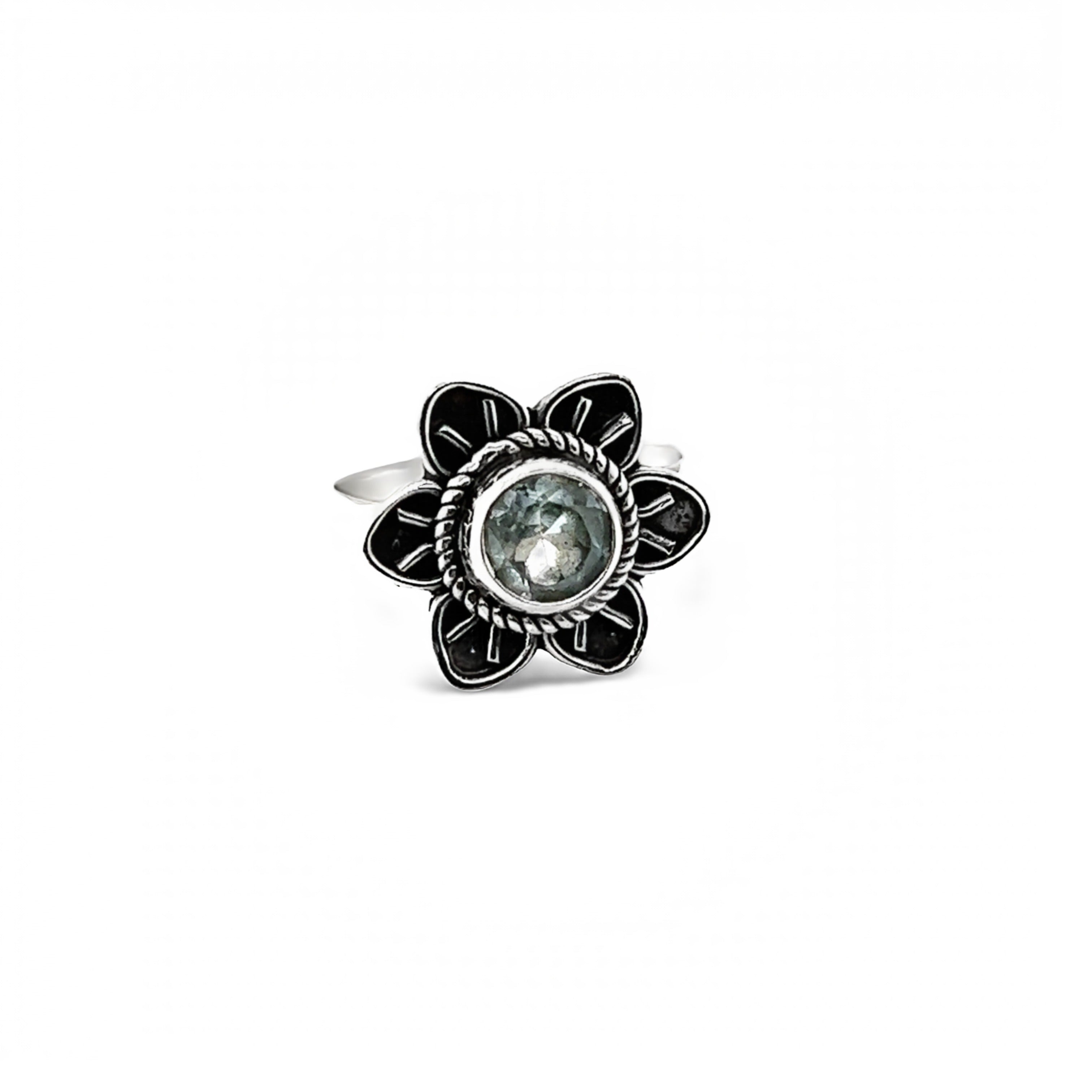 An Enchanting Flower Ring with Natural Gemstones with a blue topaz stone cabochon.