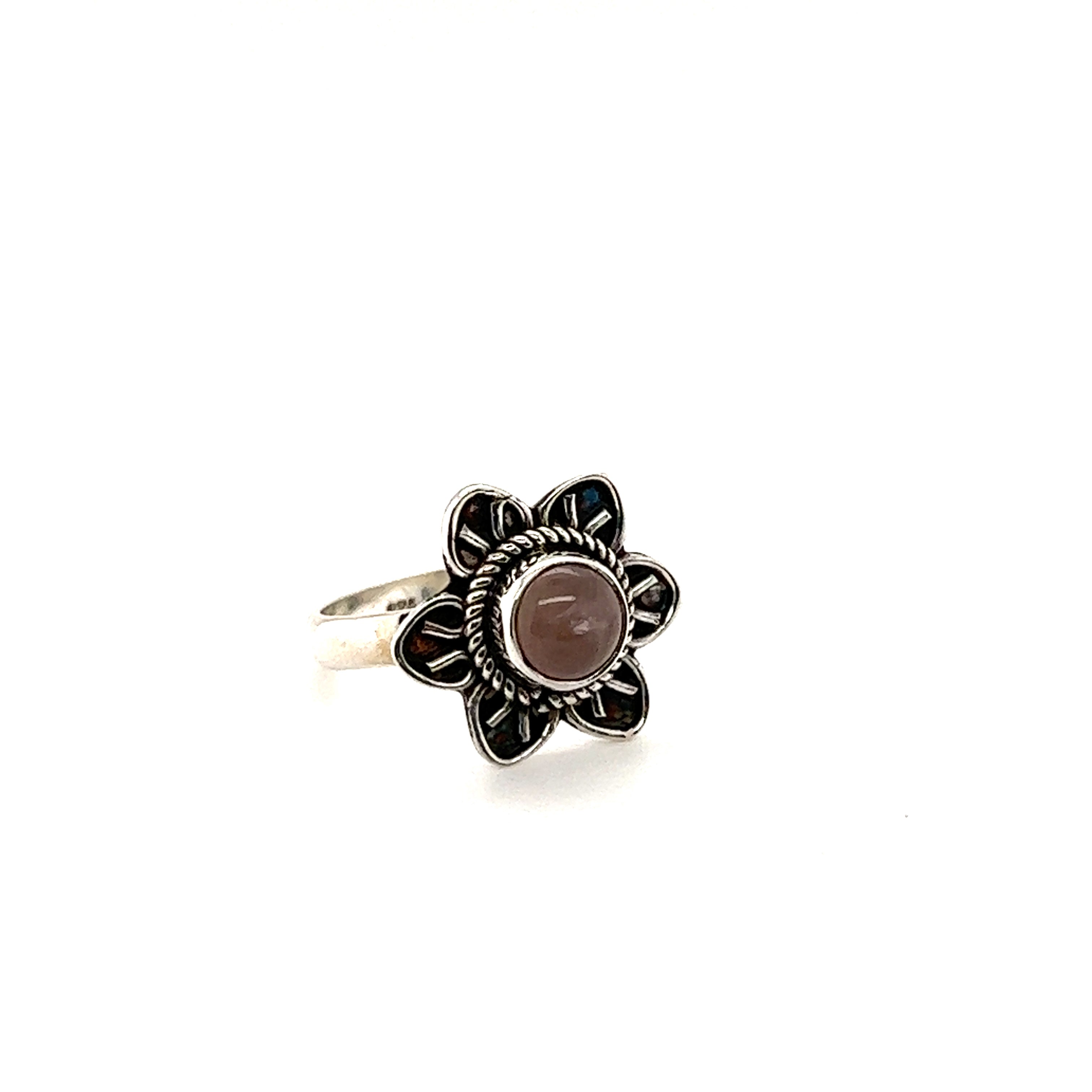 An Enchanting Flower Ring with Natural Gemstones in silver and a pink cabochon stone.