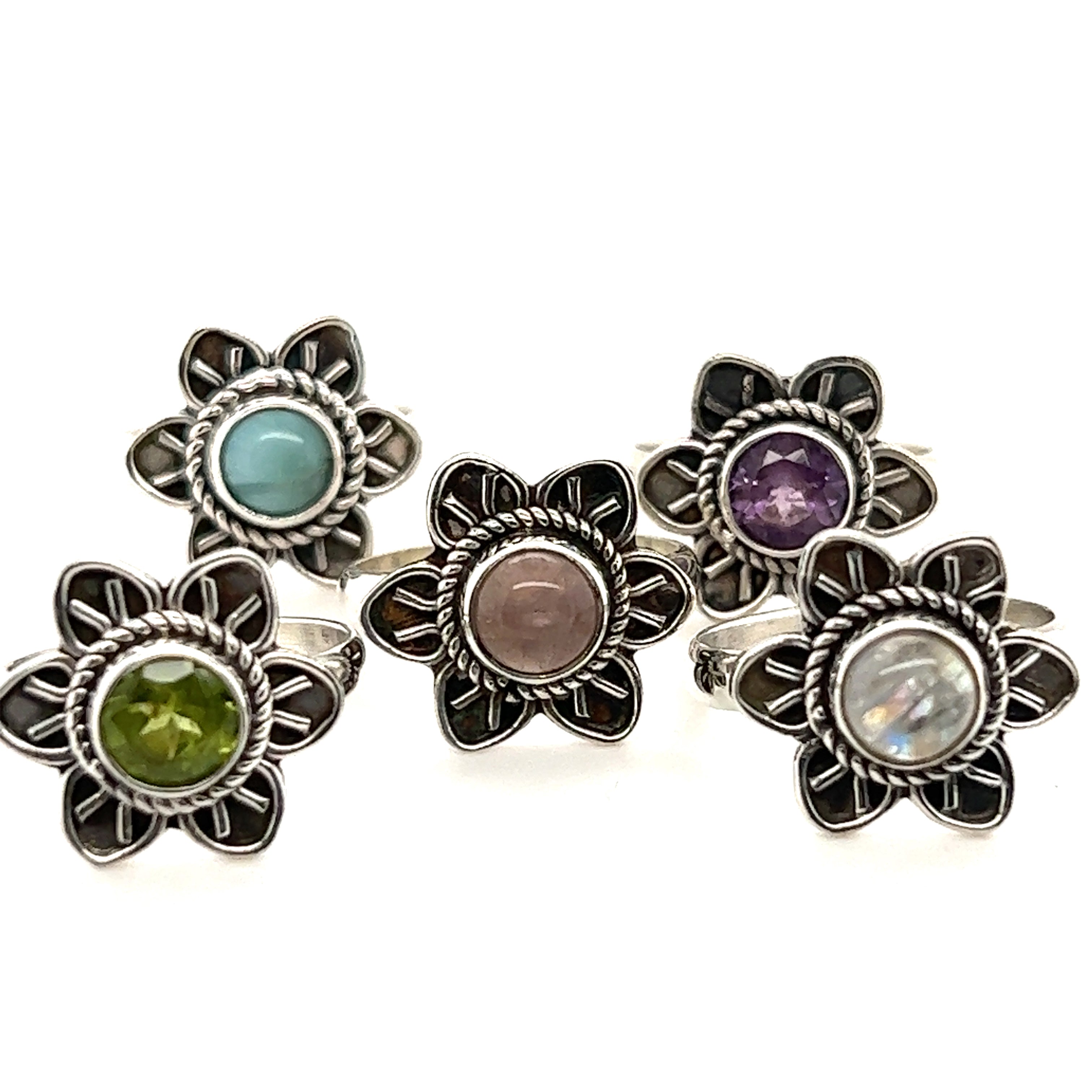 A collection of Enchanting Flower Rings with Natural Gemstones adorned in various dazzling colors from Super Silver.