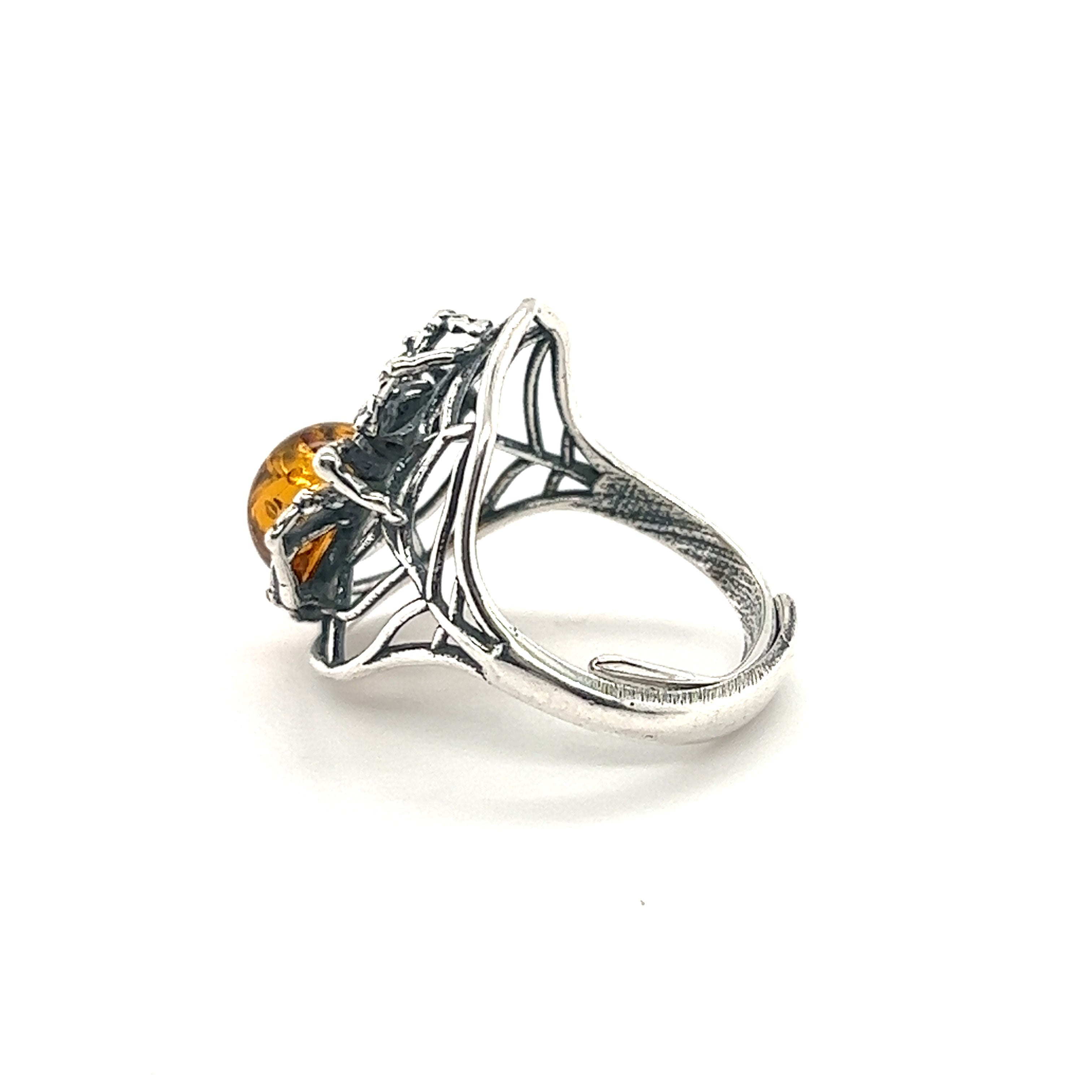 Entrancing Adjustable Baltic Amber Spider Ring with an intricate leaf design and a Baltic amber stone set in the center, isolated on a white background.