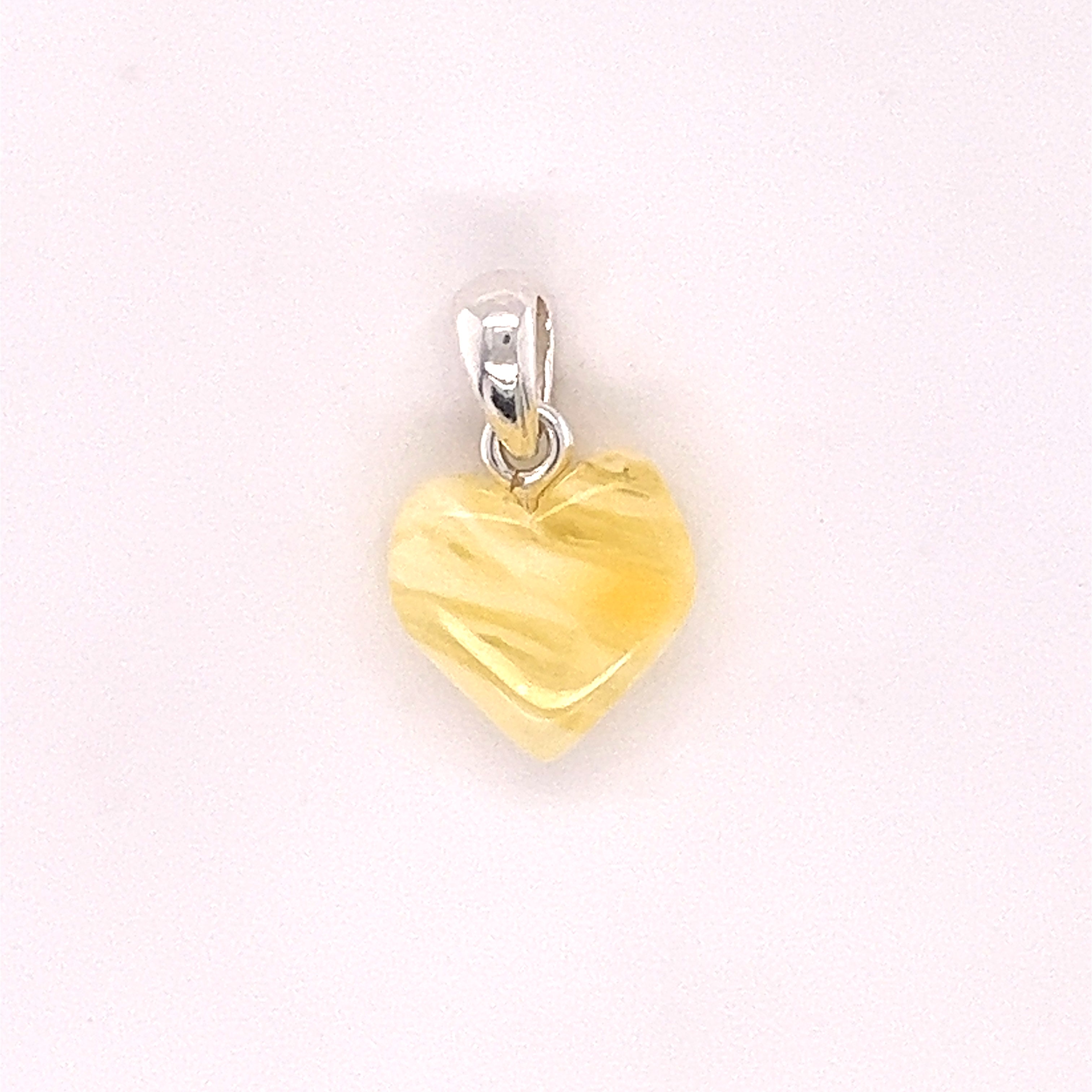 A Charming Baltic Amber Heart Pendant by Super Silver on a white background.