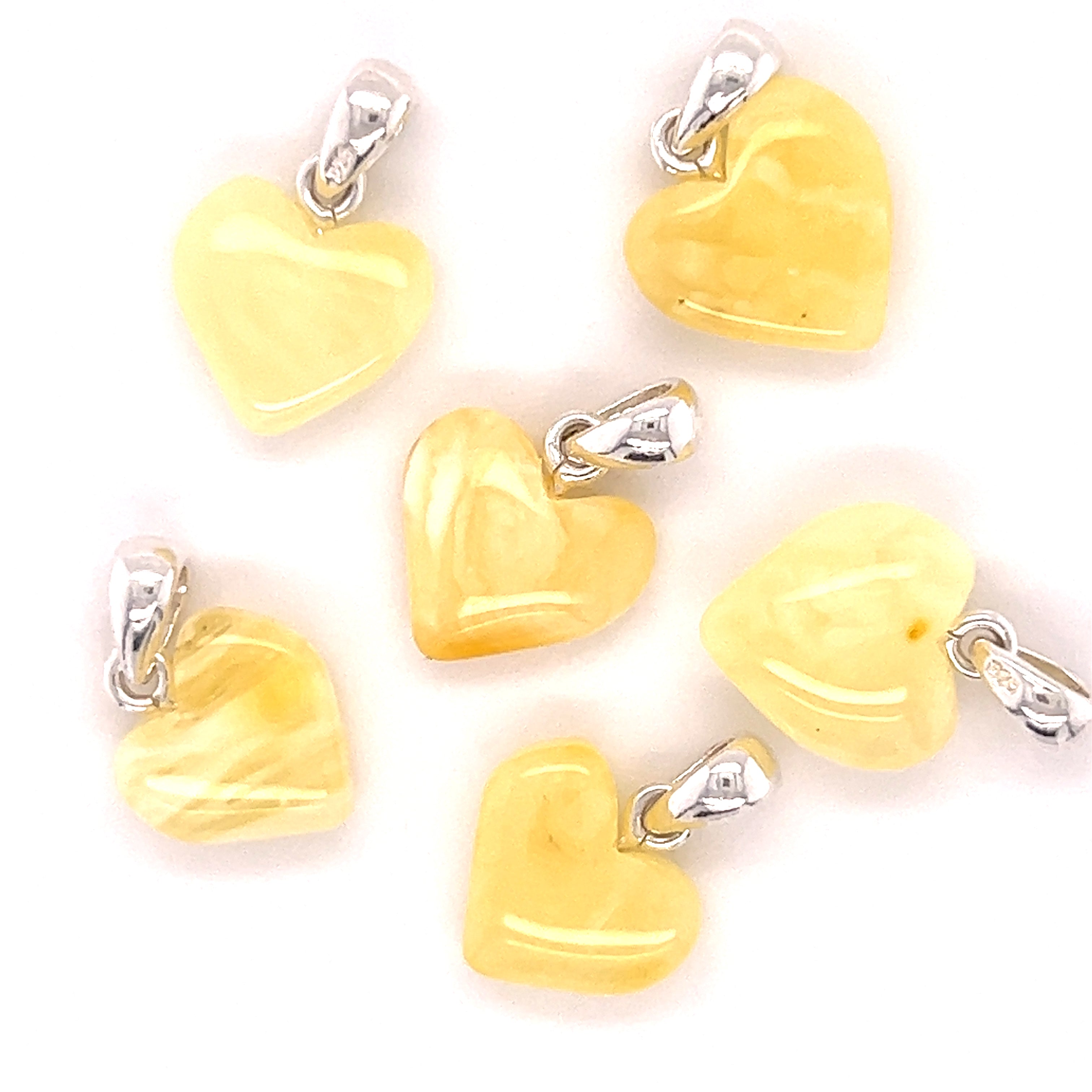 Six Super Silver Charming Baltic Amber Heart Pendants on a white background.
