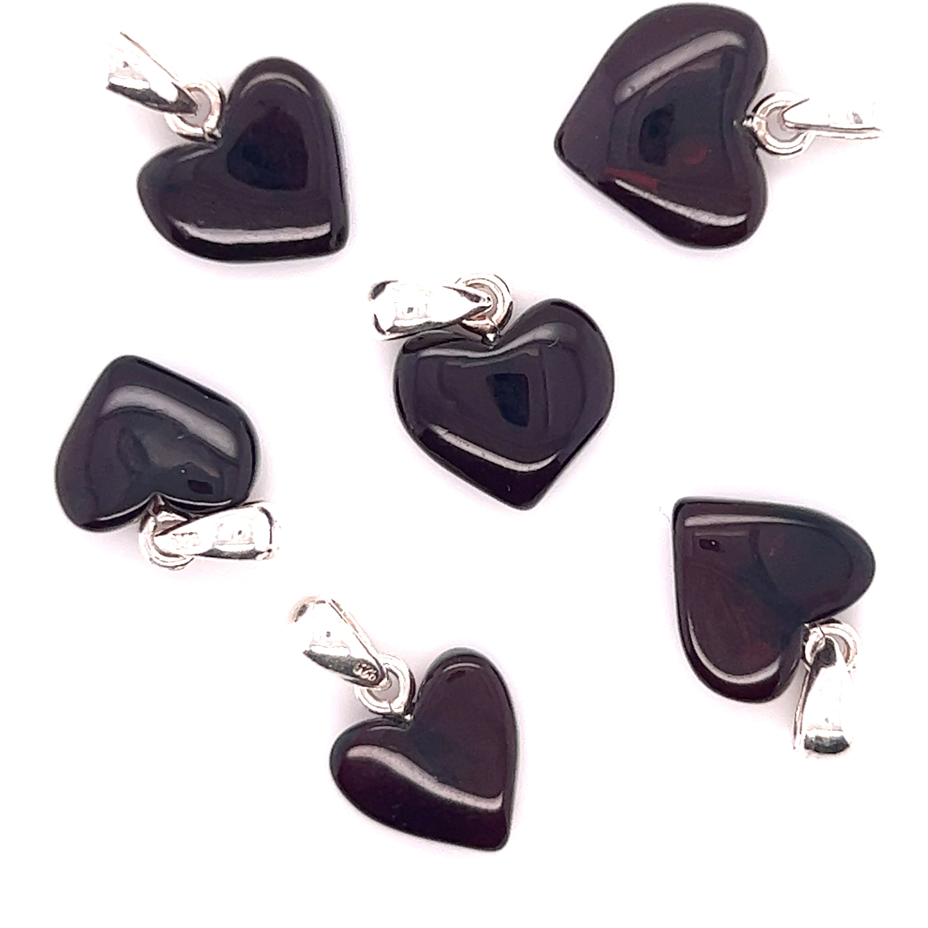 Five Super Silver Charming Baltic Amber Heart Pendants on a white background.
