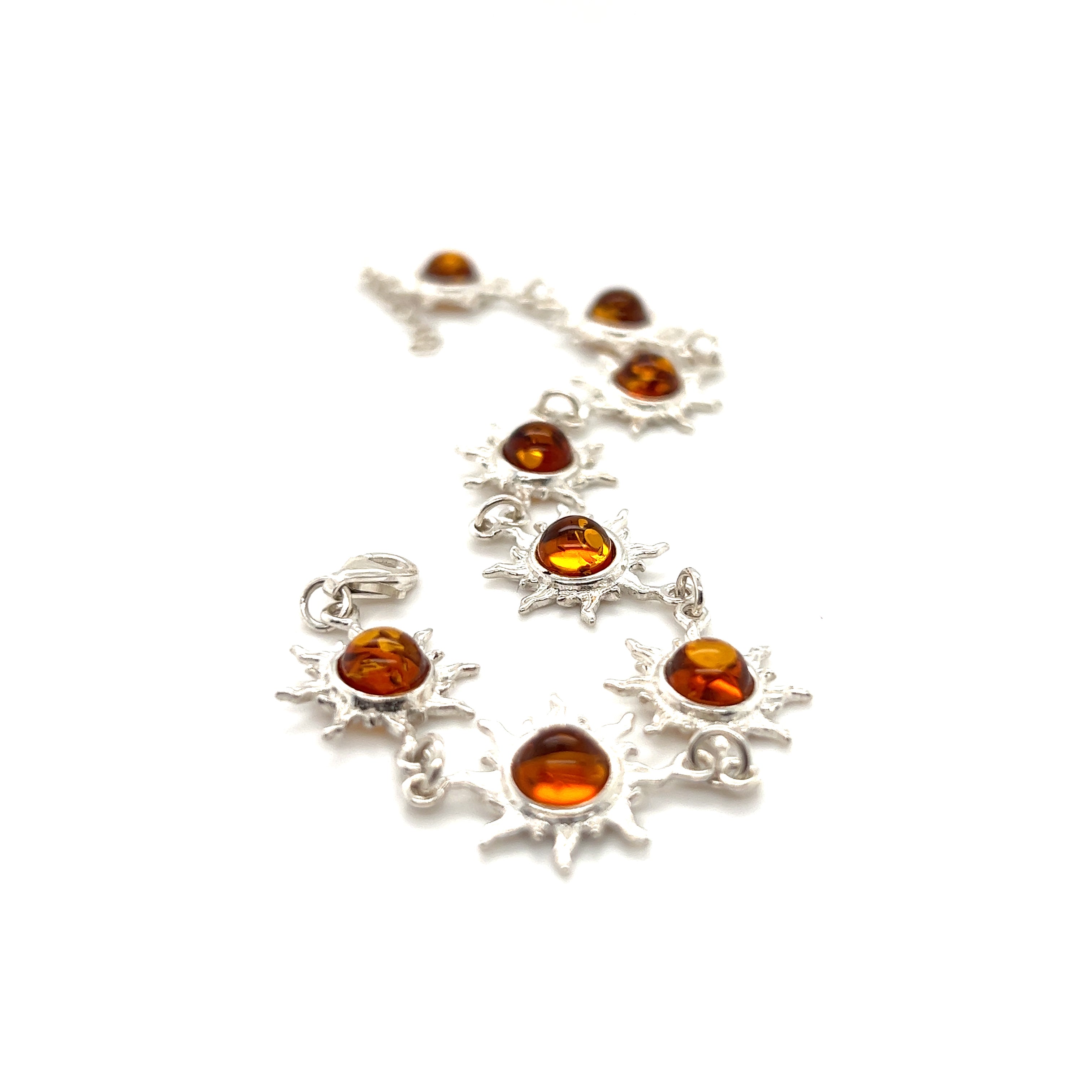 A Sparkling Amber Sun Bracelet adorned with Baltic amber stones and silver sunbursts by Super Silver.