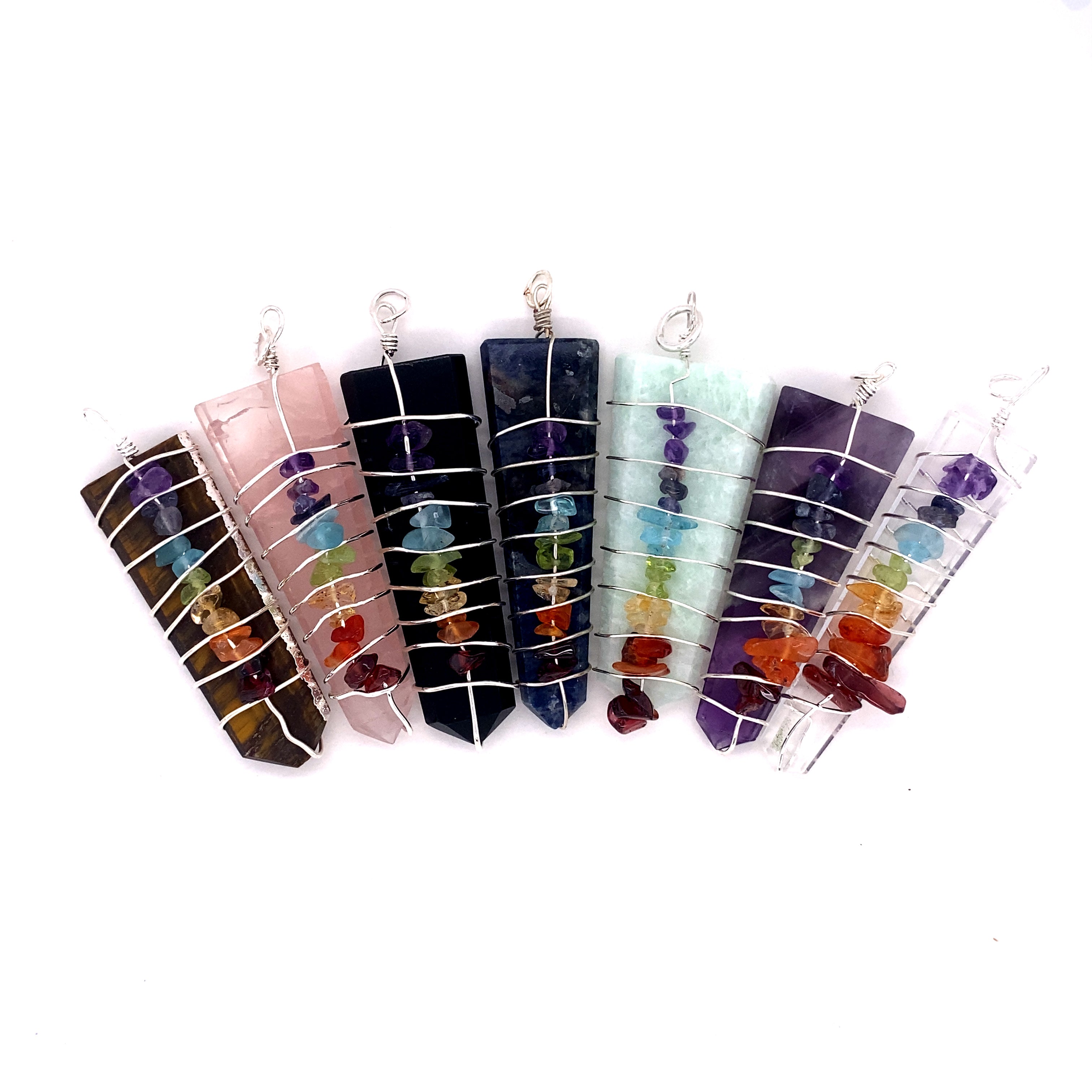 A collection of Super Silver Stone Slab Wire-Wrapped Chakra Pendants, each adorned with vibrant gemstone slab pendants.