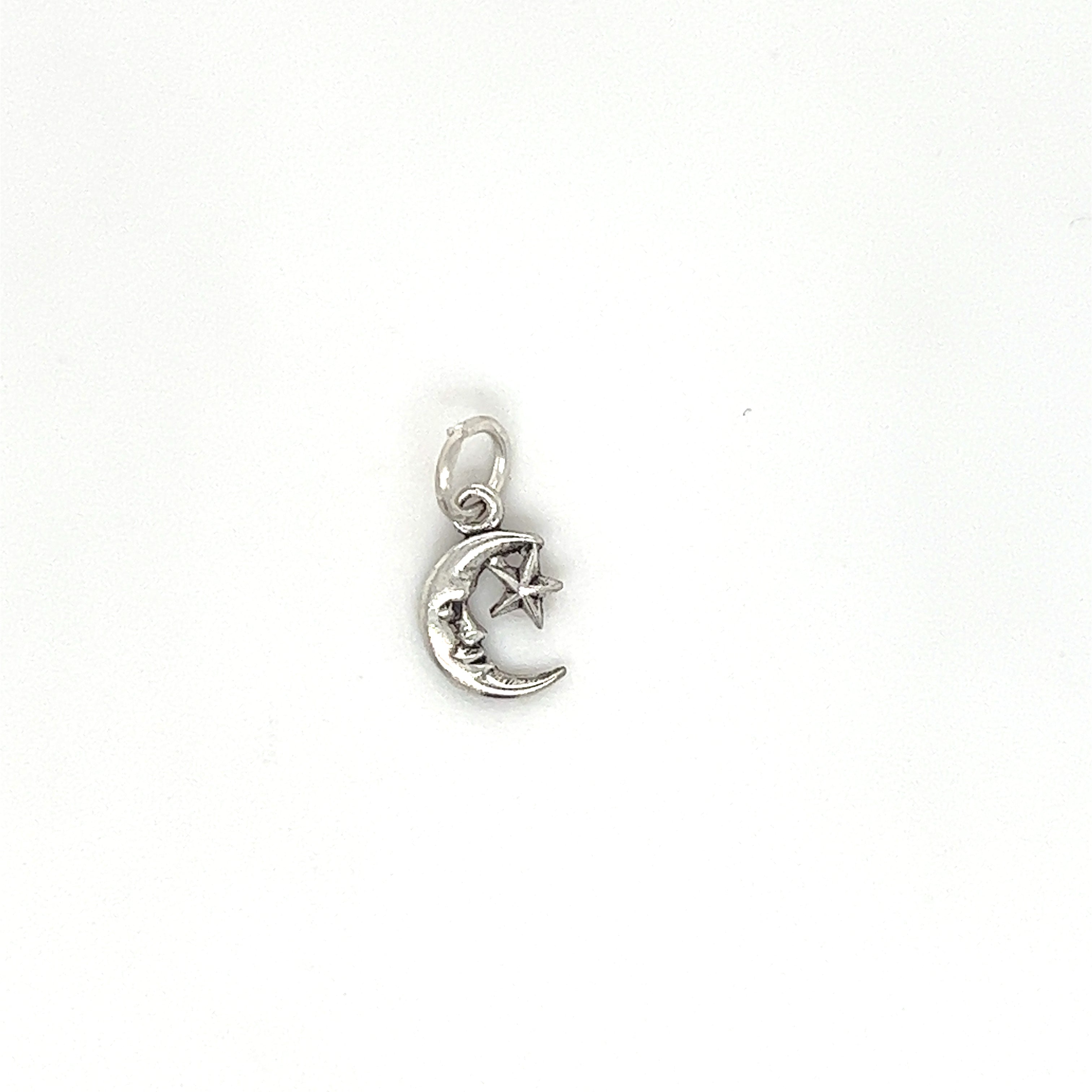 A Tiny Man in the Moon Star Charm on a white background, perfect for sky lovers and charm bracelet enthusiasts, made by Super Silver.