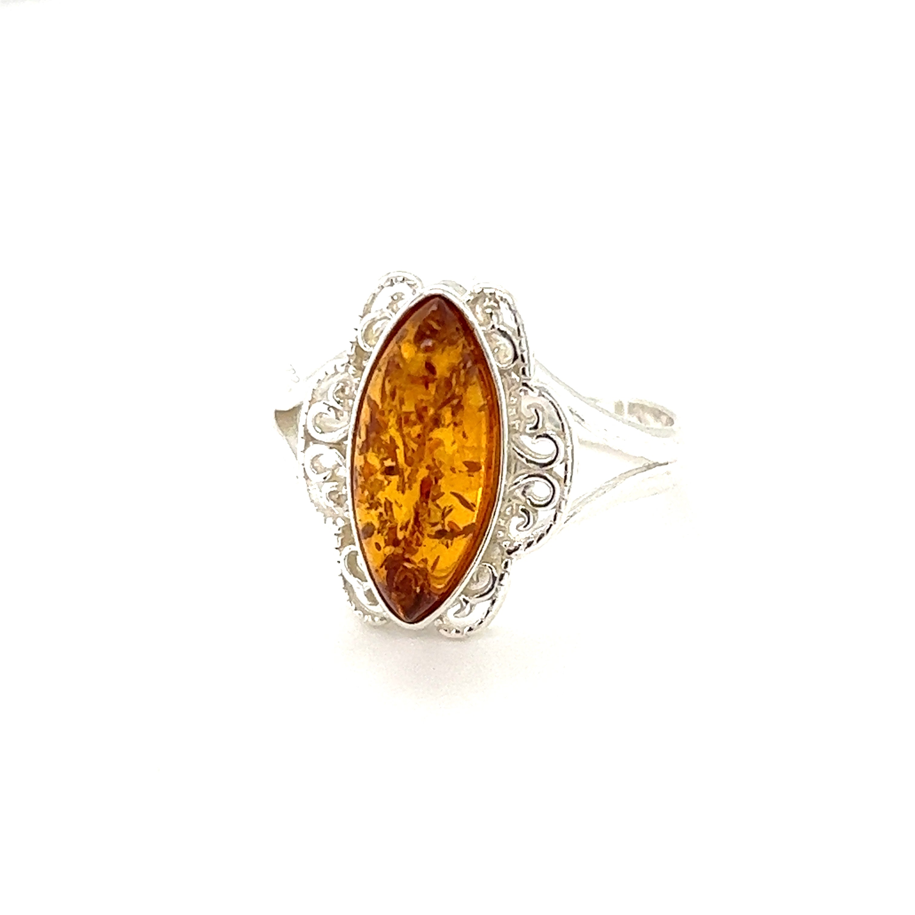 An elegant silver ring featuring an oval-shaped Baltic amber stone set in a Filigree Marquise Shaped Adjustable Amber Ring, isolated on a white background.