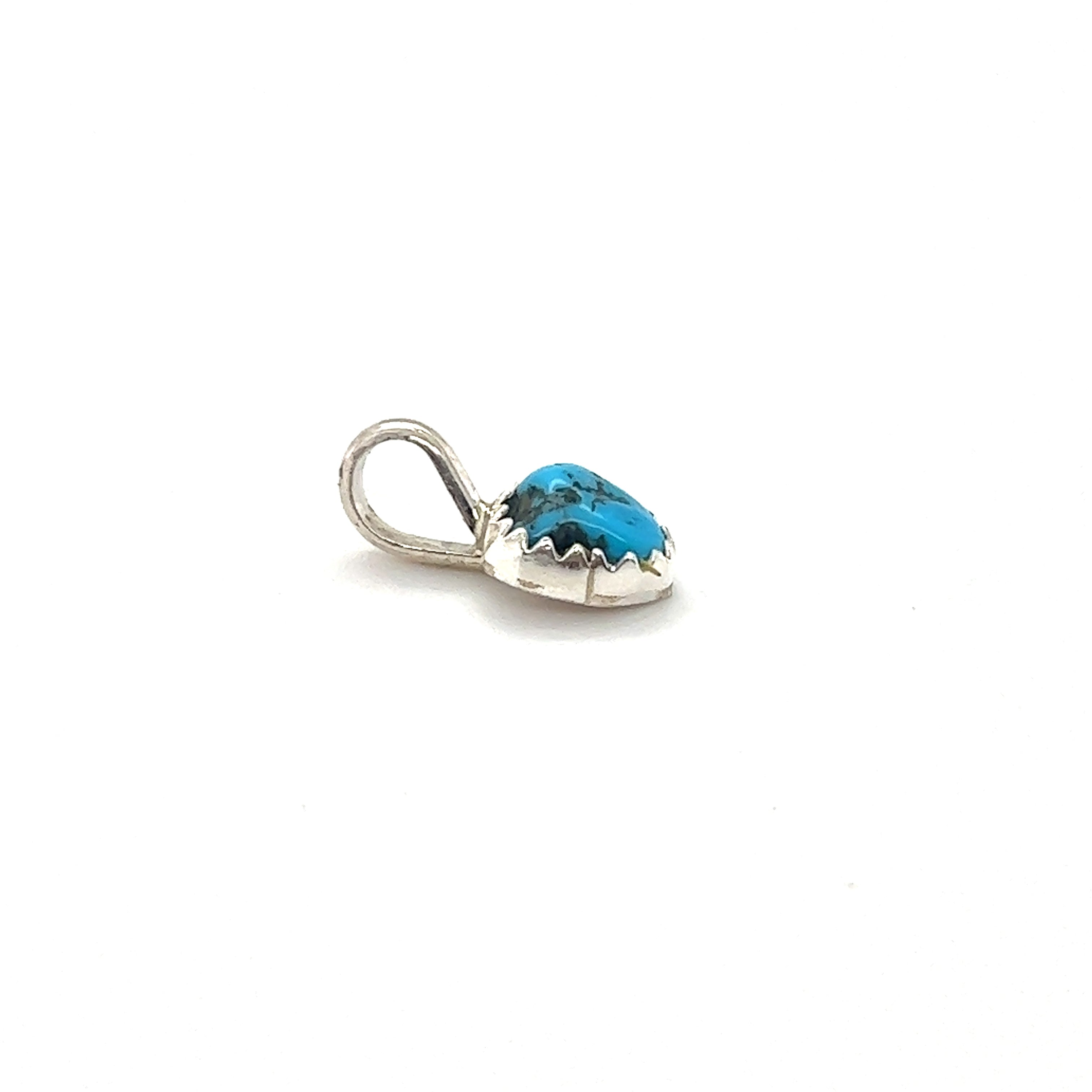 A Teeny Tiny Native American Turquoise Nugget pendant in a Super Silver claw tooth frame on a white background.