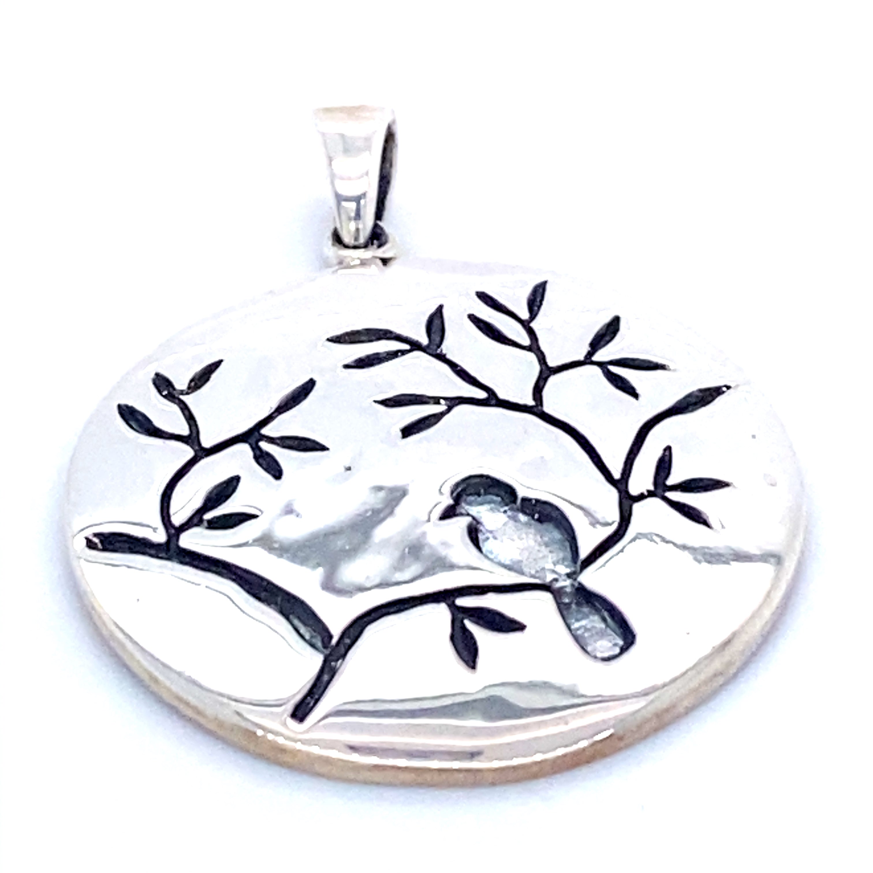 A Super Silver Large Circle Nature Pendant with Bird on a cherry blossom branch.