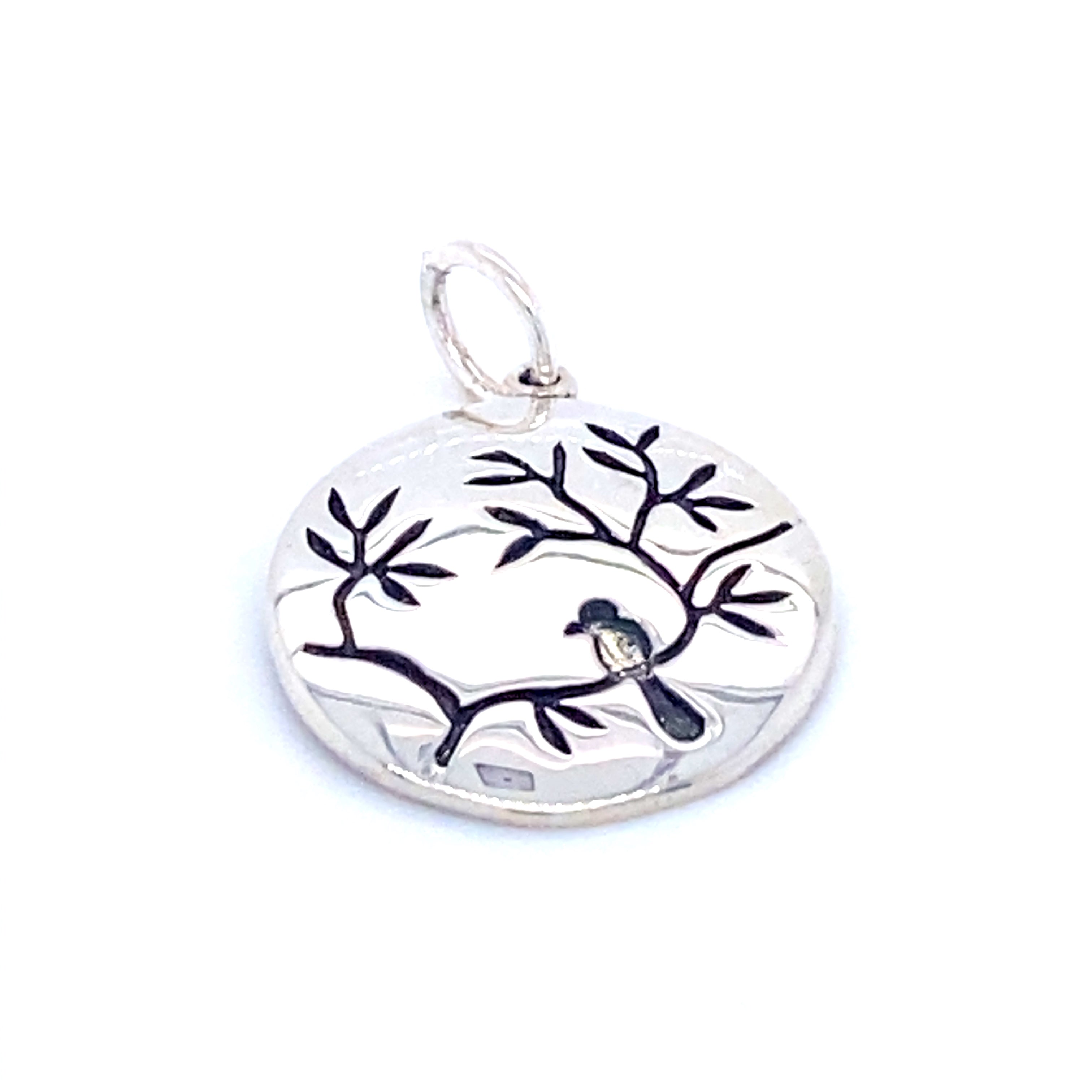 A Super Silver Small Circle Nature Charm With Bird pendant with a bird and cherry blossom design.