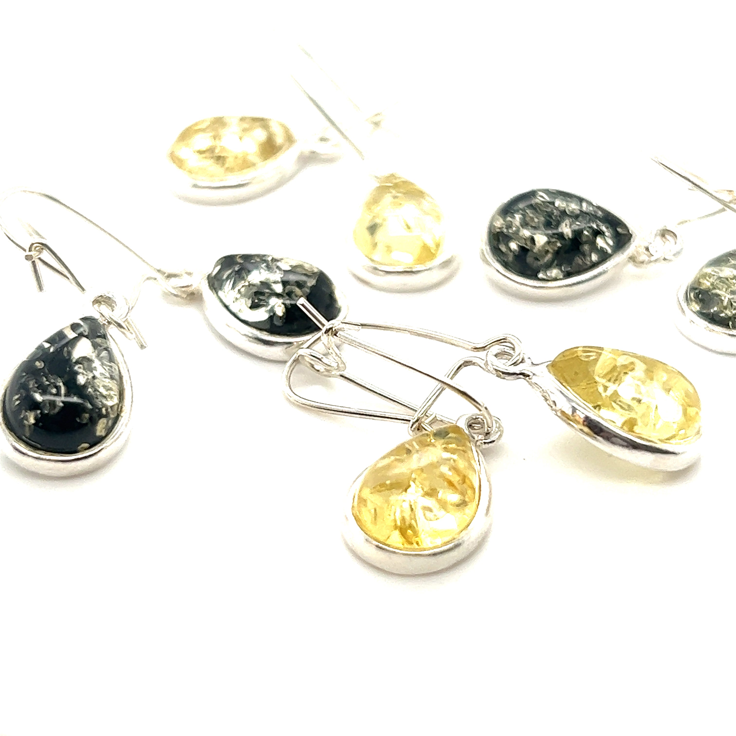 A pair of Charming Baltic Amber Teardrop Earrings by Super Silver with sparkling yellow and black stones.