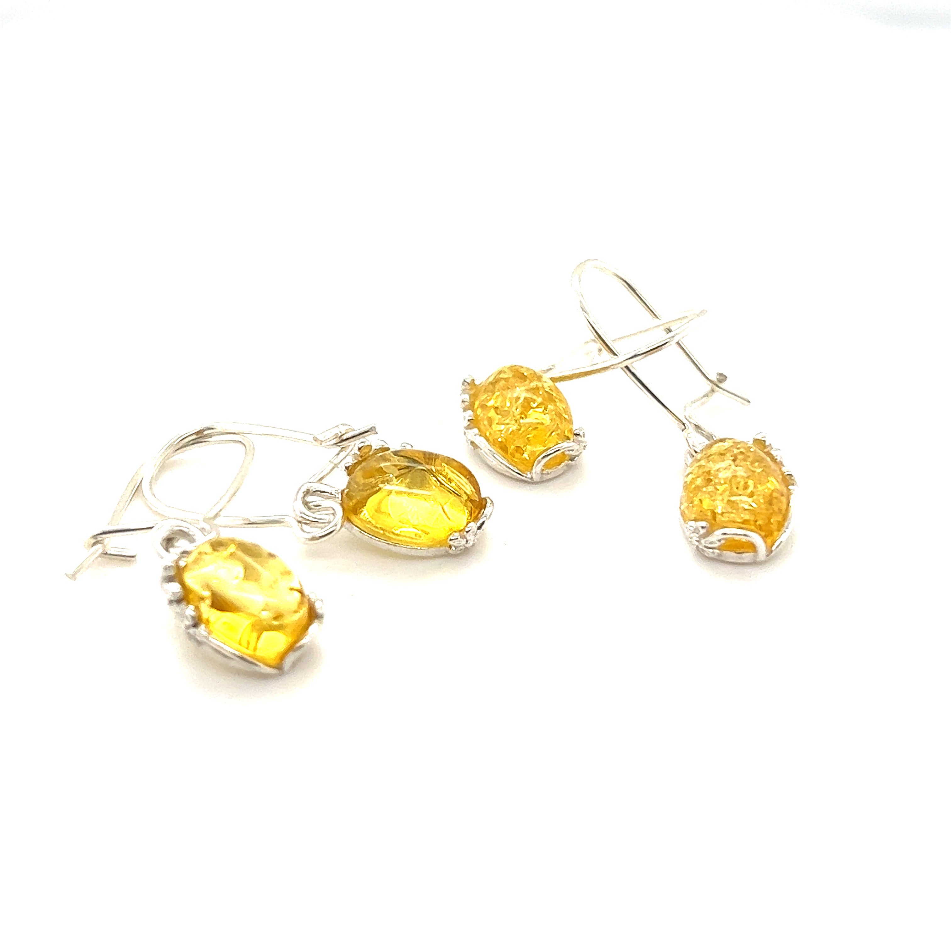 A pair of Super Silver Tiny Glowing Oval Amber Earrings showcasing natural elegance with yellow crystals on a white background.
