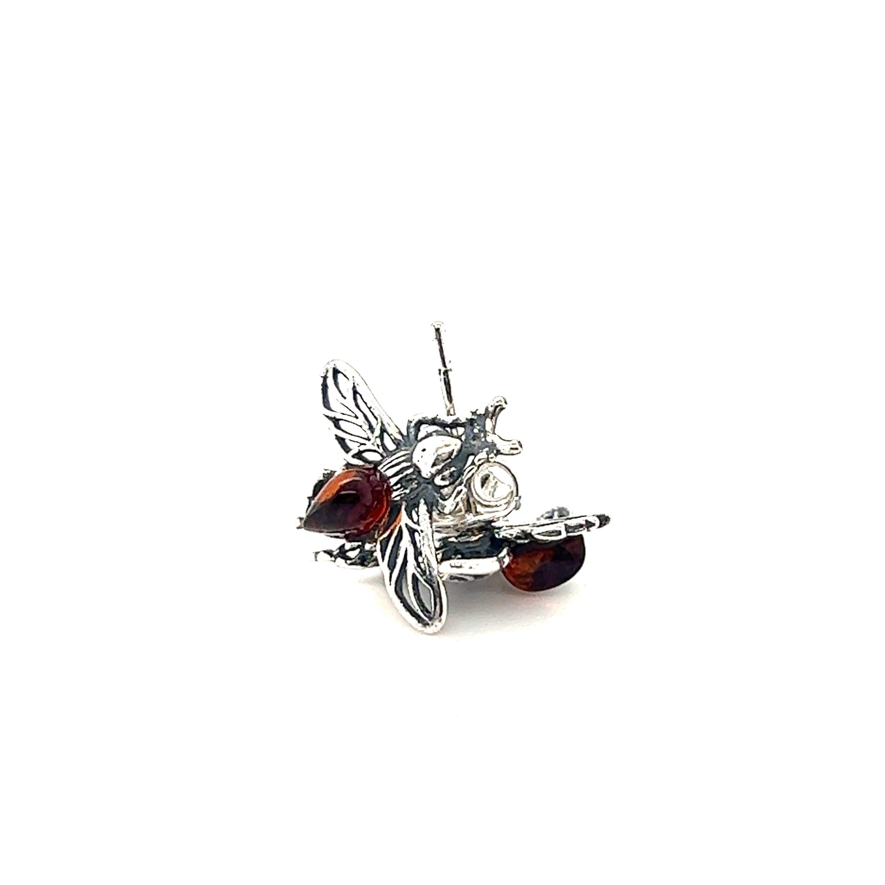 A bee is sitting on top of a pair of Detailed Baltic Amber Bee Studs by Super Silver.