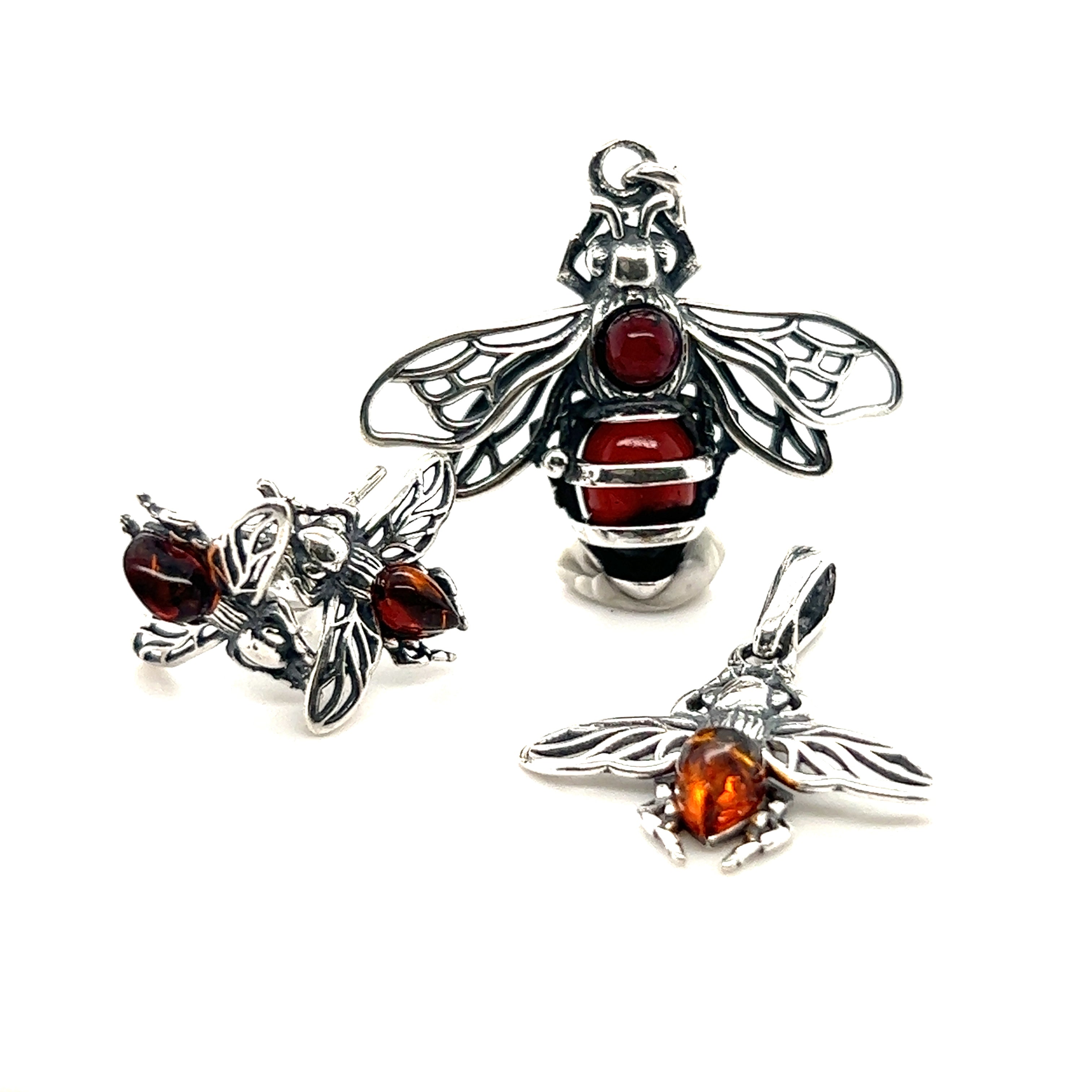 A stunning Super Silver Charming Amber Bee Pendant necklace and matching earrings featuring Baltic amber accents. Crafted with high-quality .925 sterling silver.