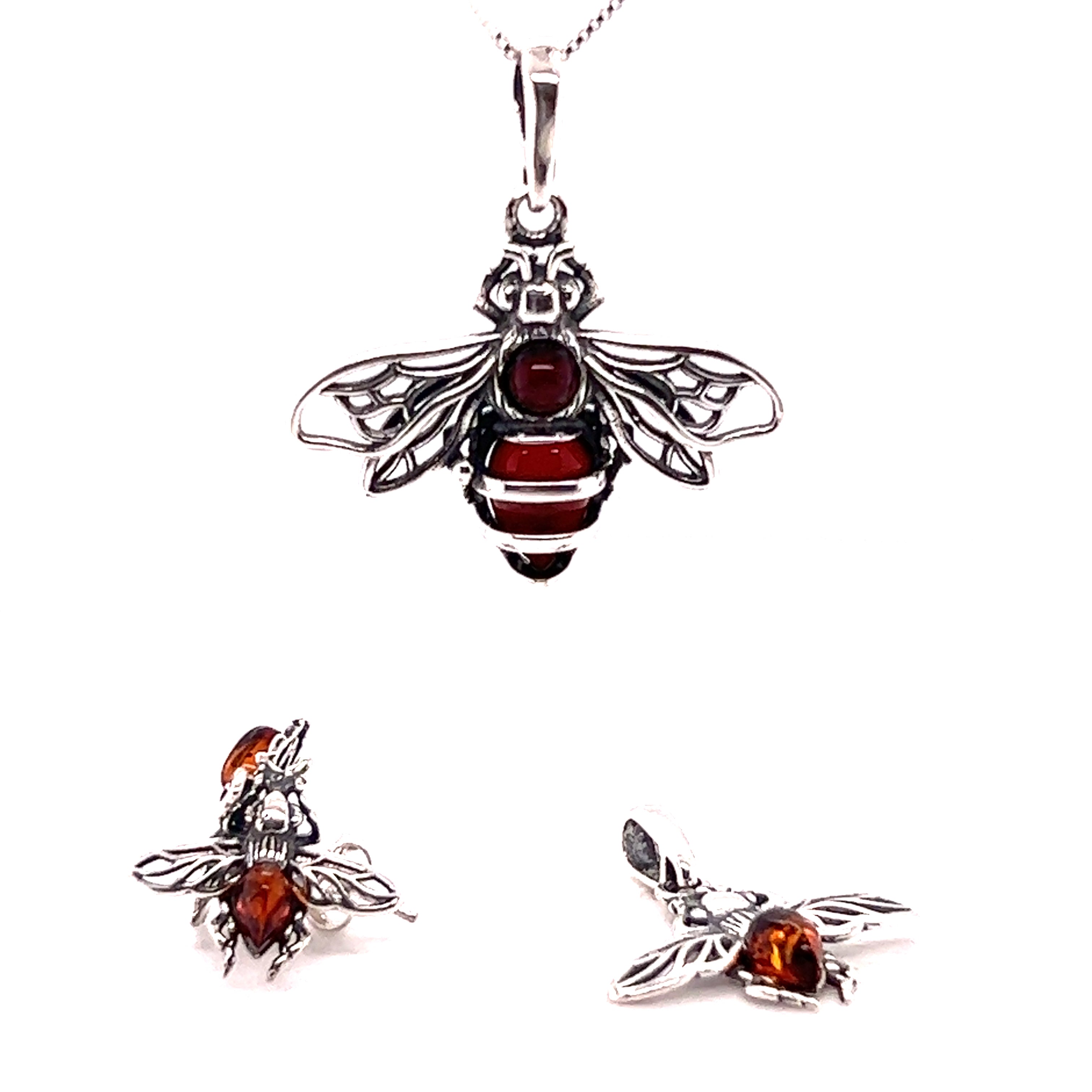 A Super Silver detailed Baltic Amber Bee pendant and earrings set with a red garnet stone and Baltic amber.