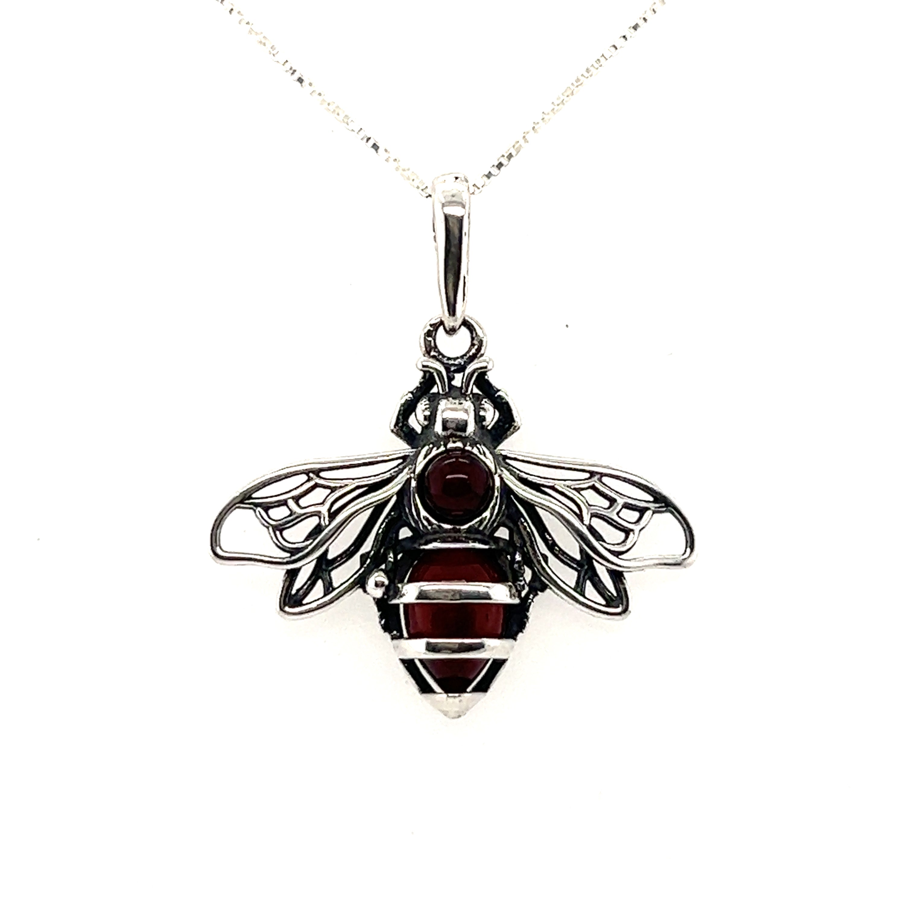 A Charming Amber Bee Pendant by Super Silver with garnet stones on a .925 sterling silver chain.