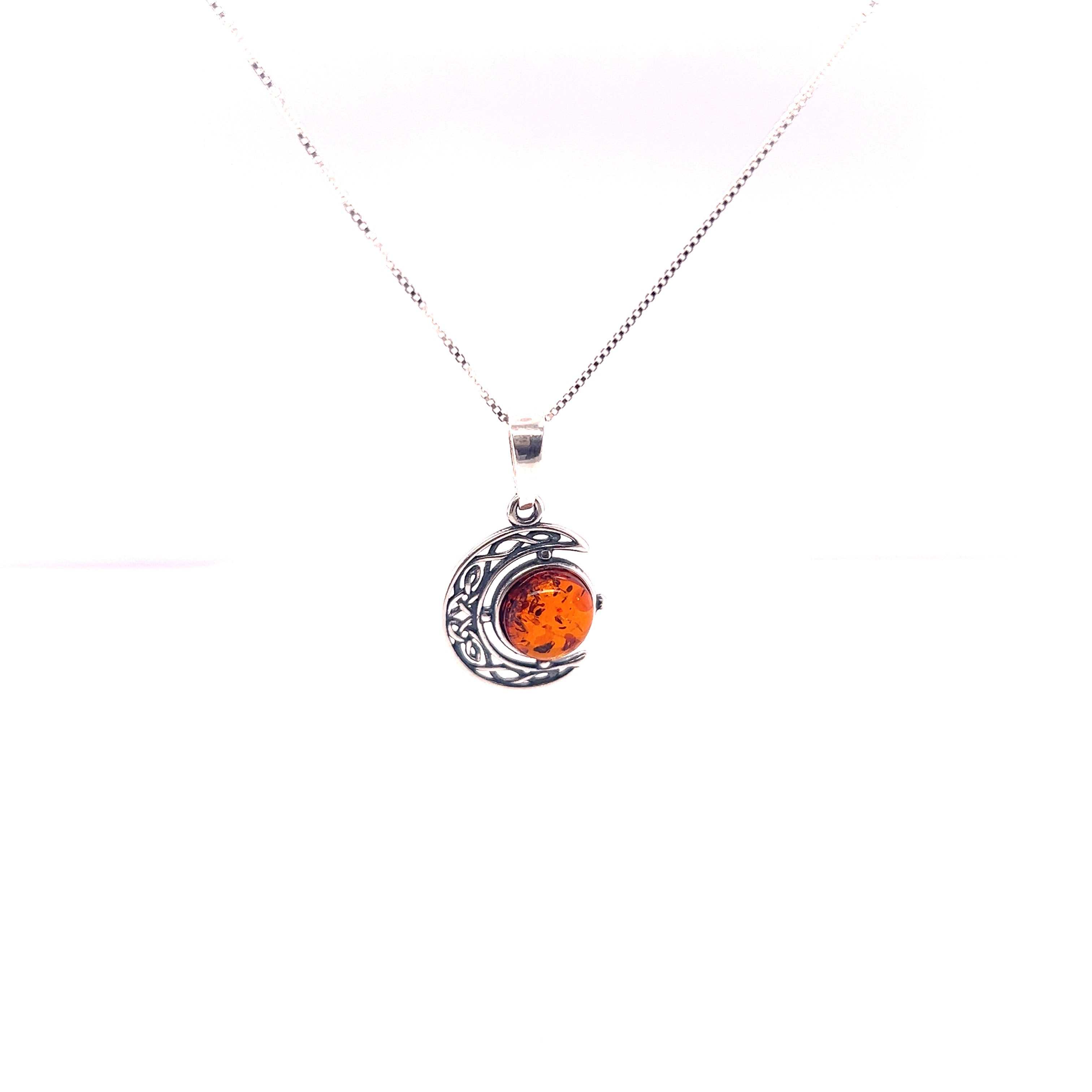 A Super Silver Baltic amber pendant adorned with a Celtic Amber Crescent Moon, showcasing exquisite Celtic artistry.