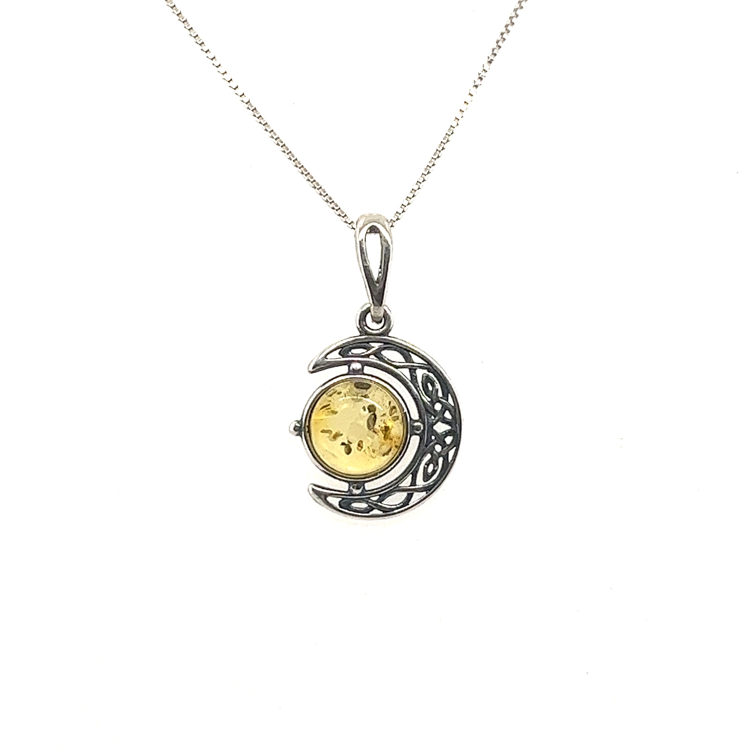 A Celtic Amber Crescent Moon Pendant with a Baltic amber stone.