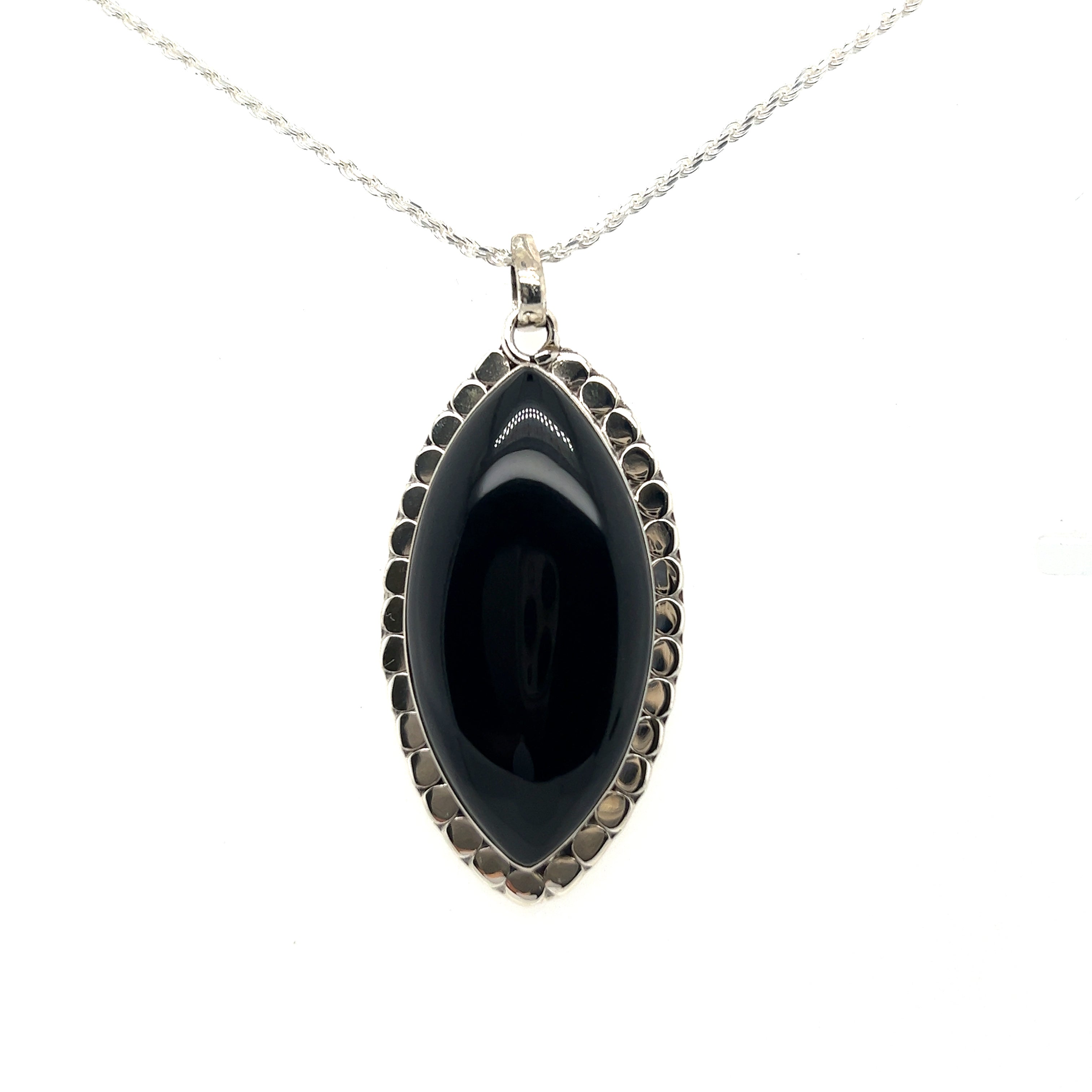 A powerful Statement Onyx Pendant With a Textured Setting by Super Silver on a silver chain.