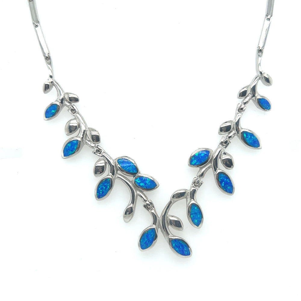 
                  
                    A Super Silver Elegant Opal Vine Necklace adorned with blue opal leaves.
                  
                