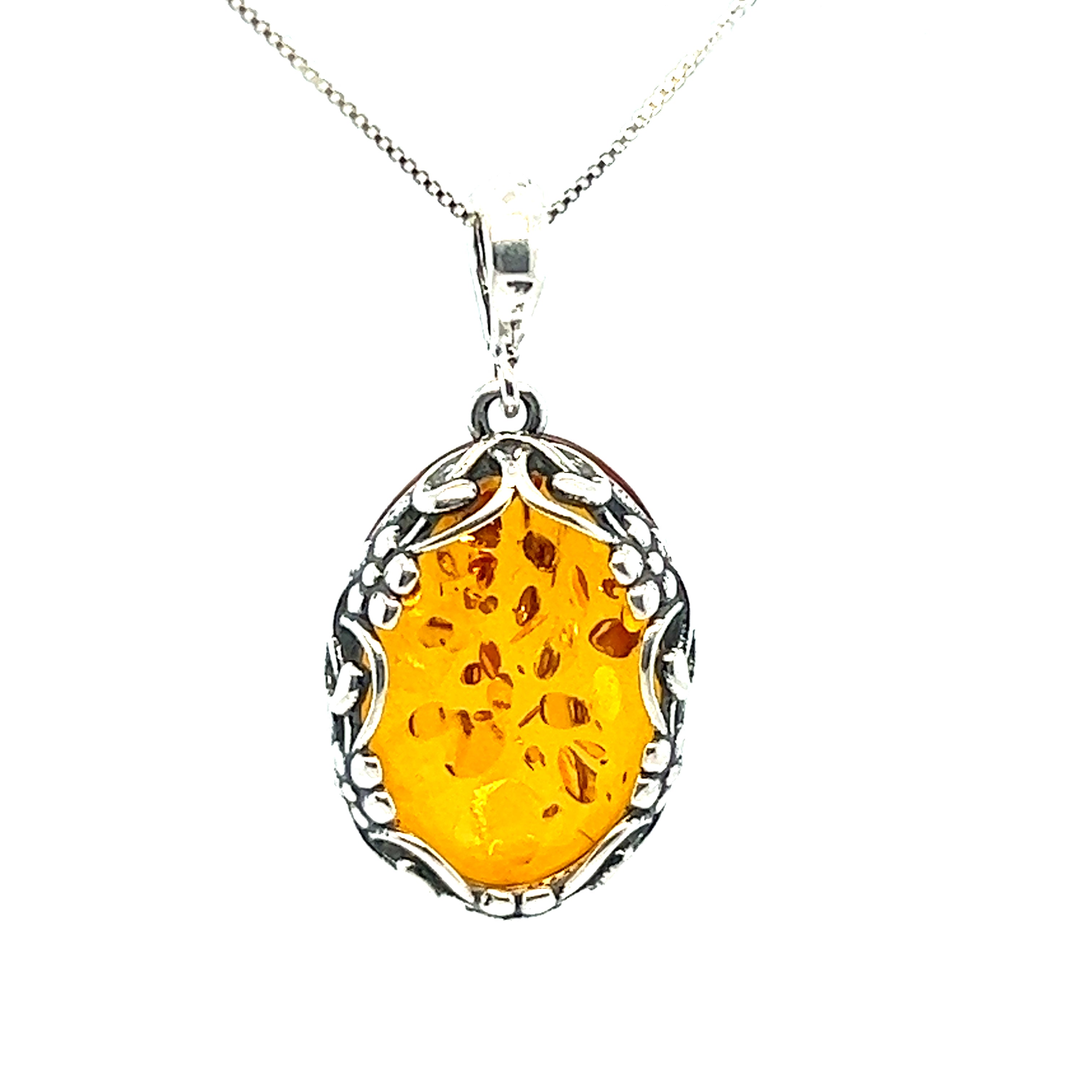 Cognac Amber Oval Pendant with Floral Border by Super Silver.