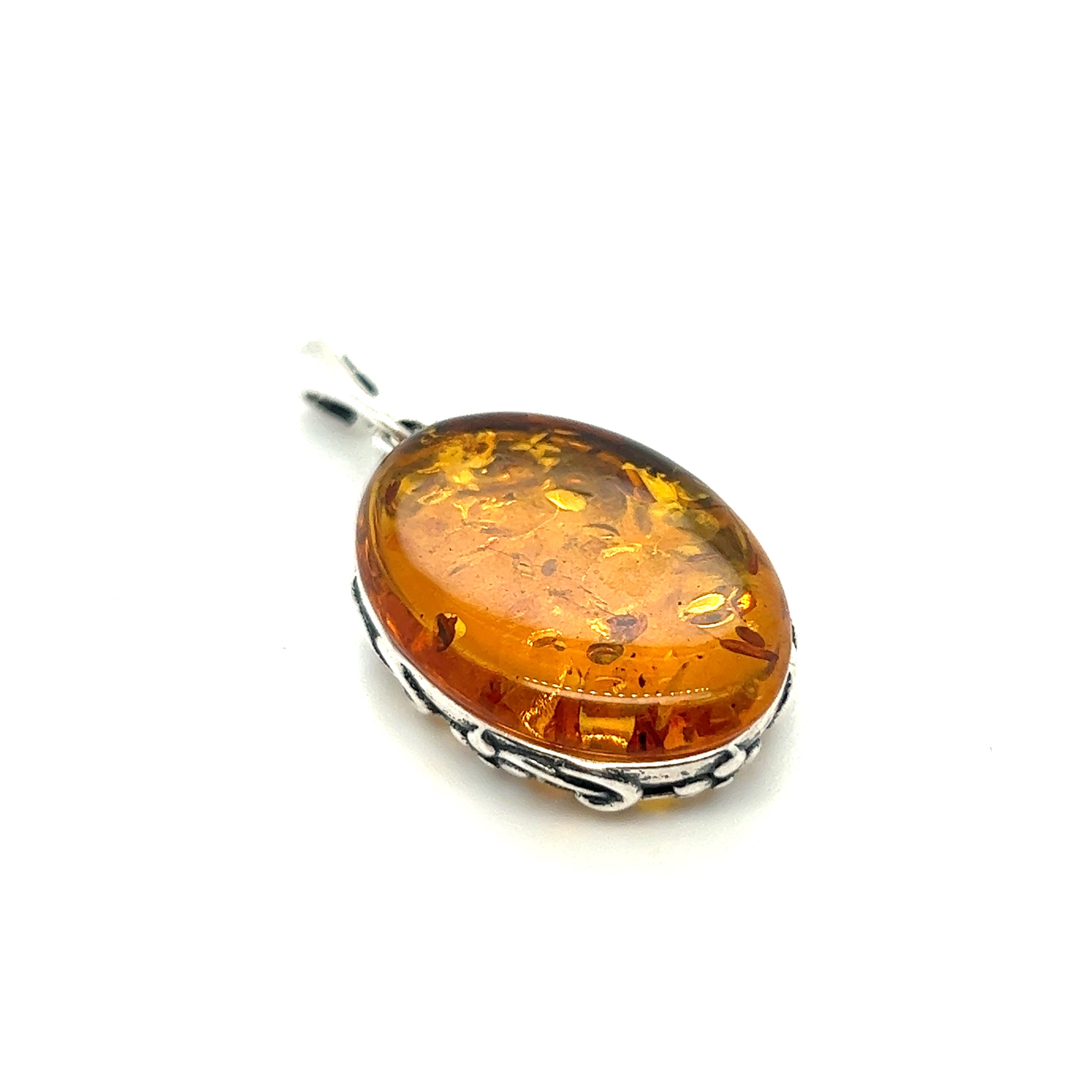 A vintage-styled Cognac Amber Oval Pendant with Floral Border by Super Silver on a white background.