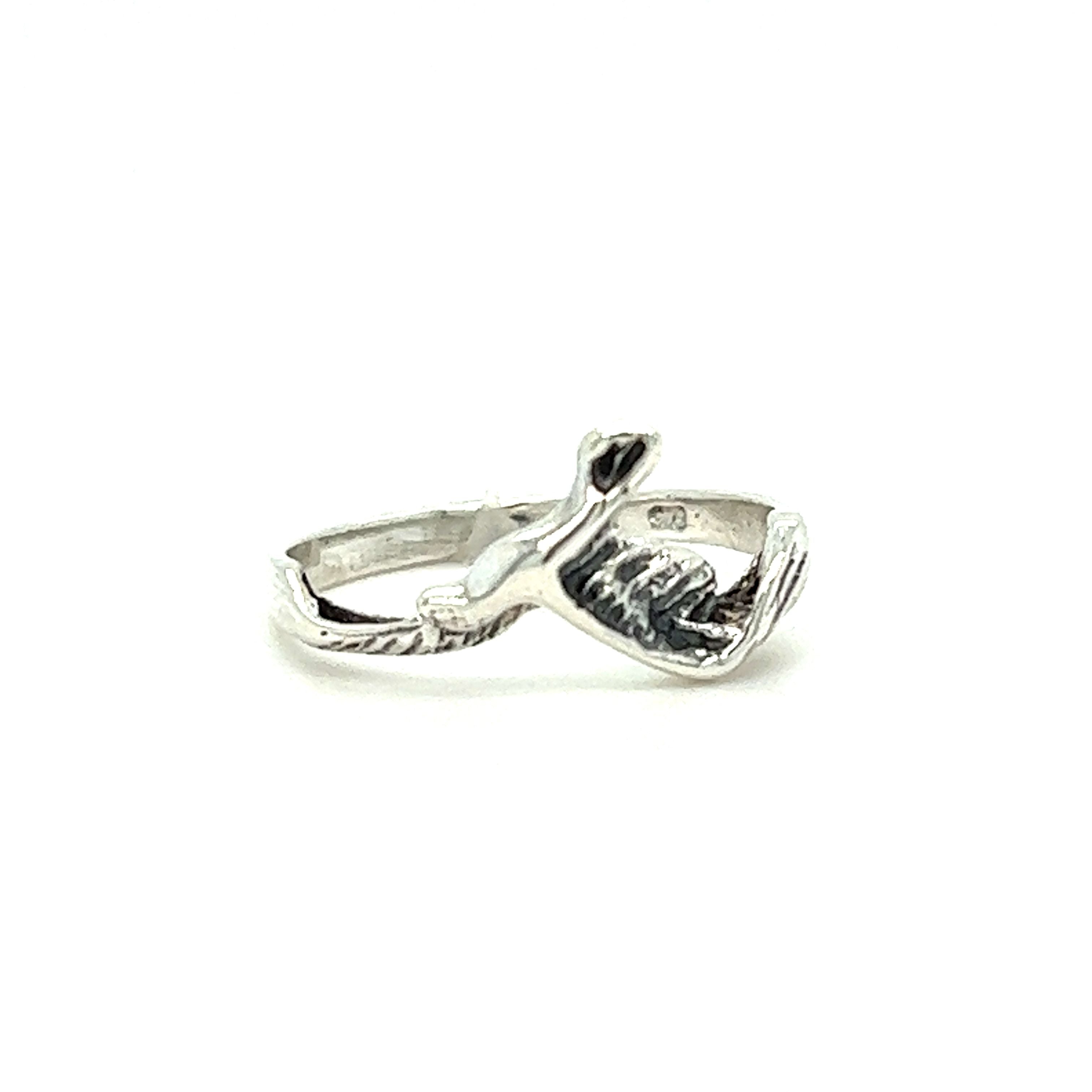 A Dainty Flying Seagull Ring with a fish and bird on it, inspired by the ocean coast and seagulls, made by Super Silver.