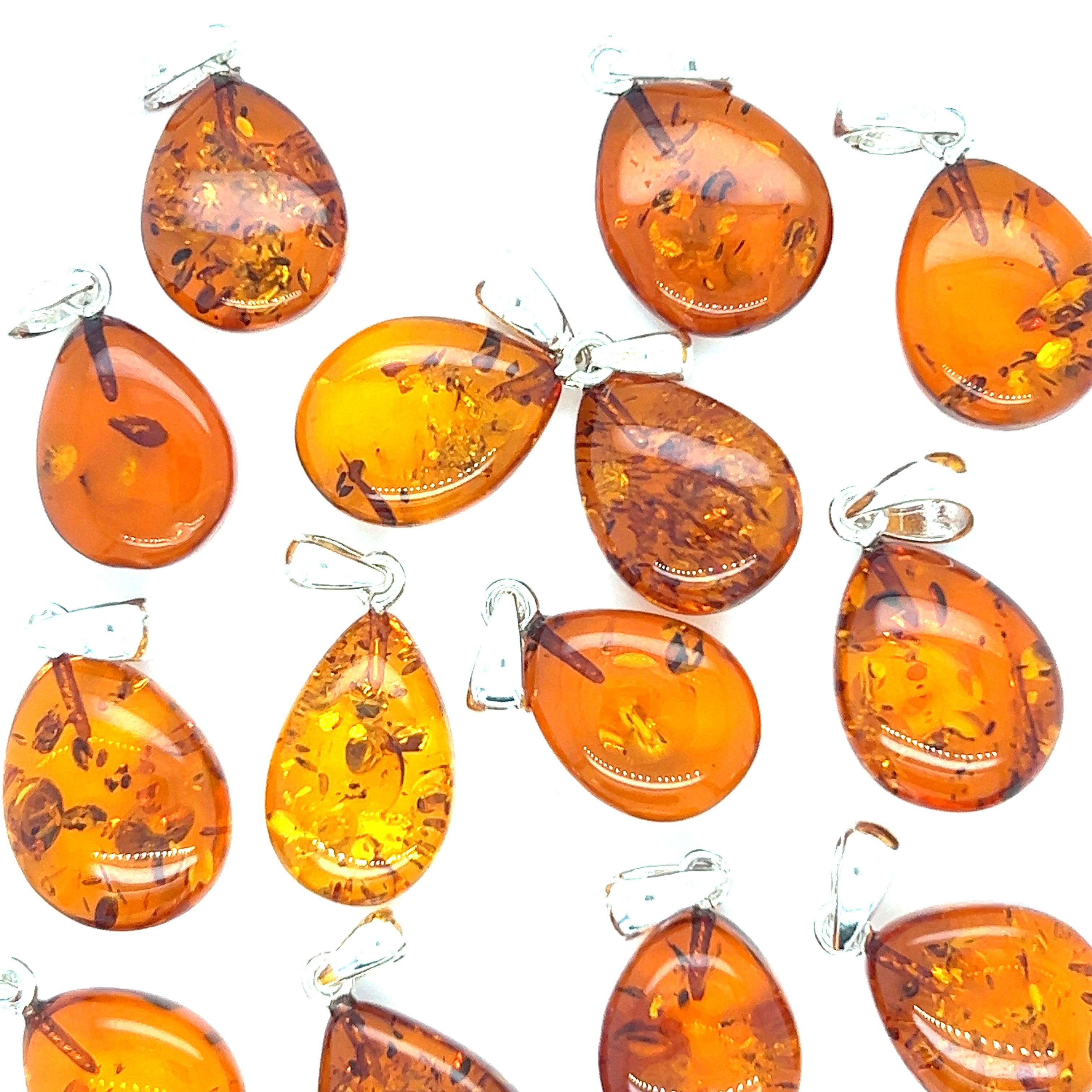 A group of Super Silver Teardrop Amber Pendants on a white background.