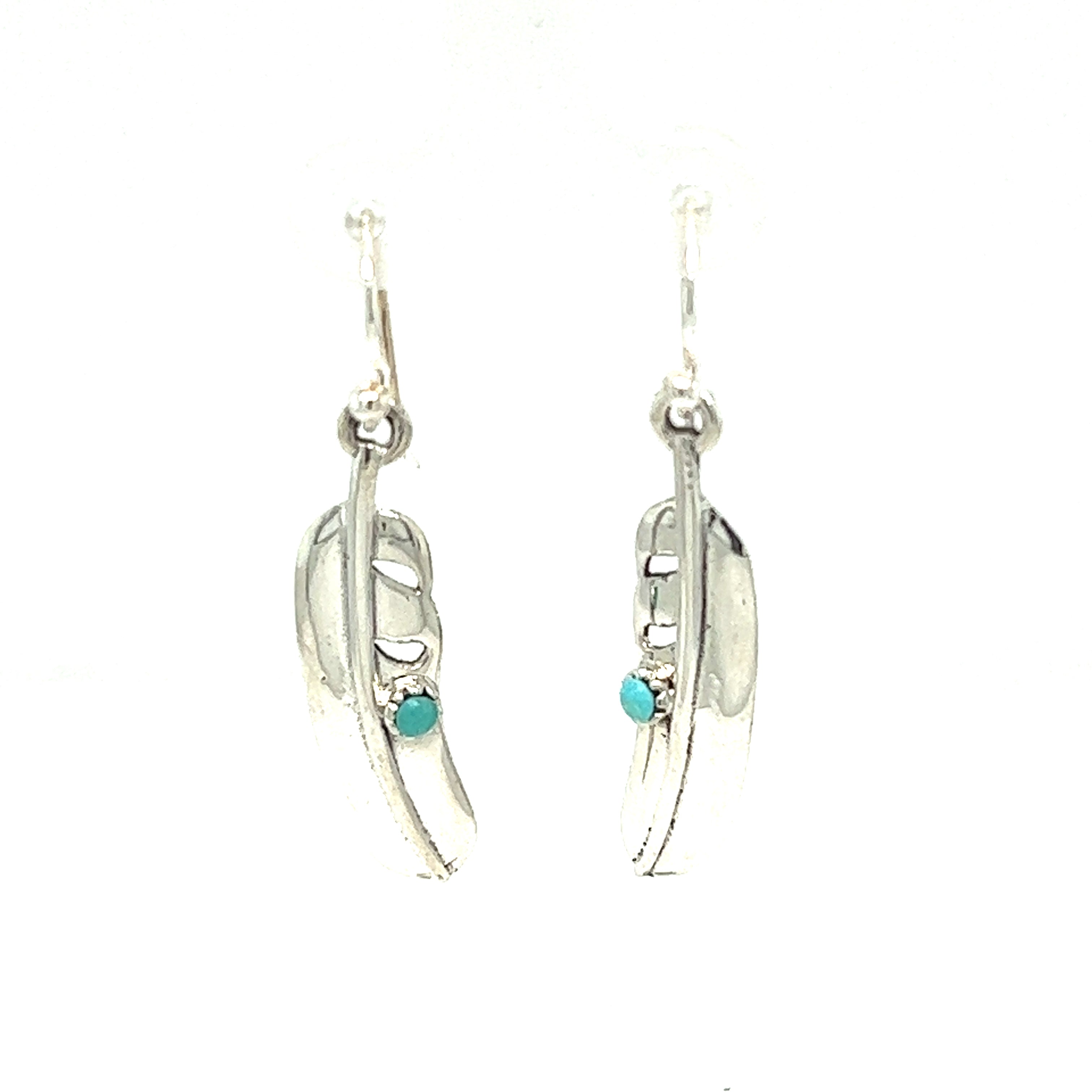A pair of Super Silver High Shine Feather Earrings with Turquoise stones, perfect for adding boho charm to any outfit.
