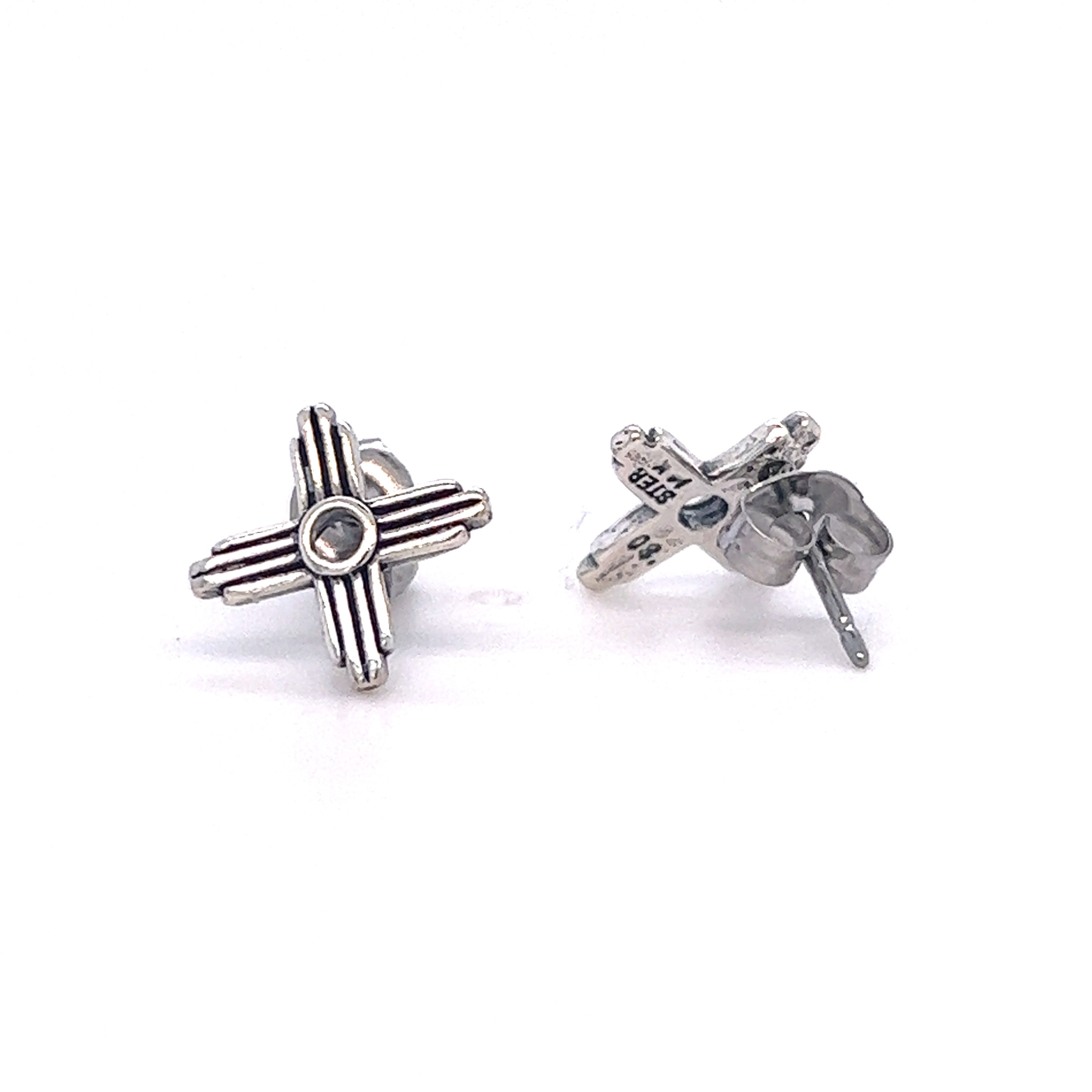 A pair of Super Silver Zia Sun Studs, featuring a cross symbolizing the Zia sun.