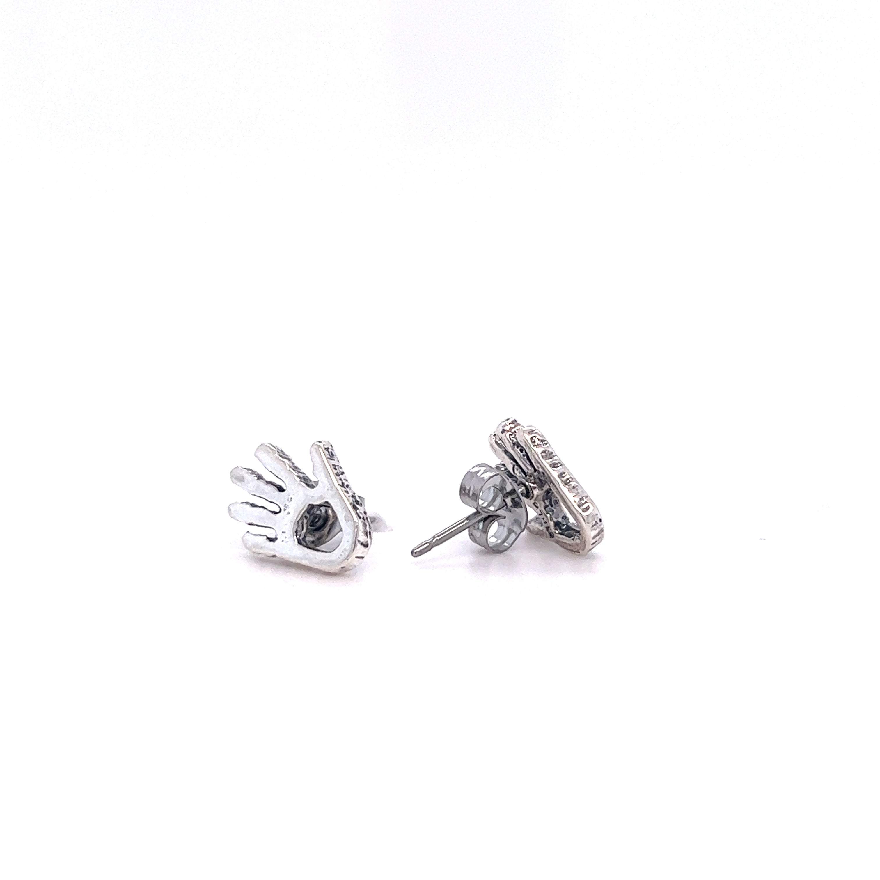 A pair of Super Silver Petroglyph Hand Studs, showcasing an intricate hand petroglyph design that pays homage to the ancient Anasazi people and their beliefs in helping and healing.