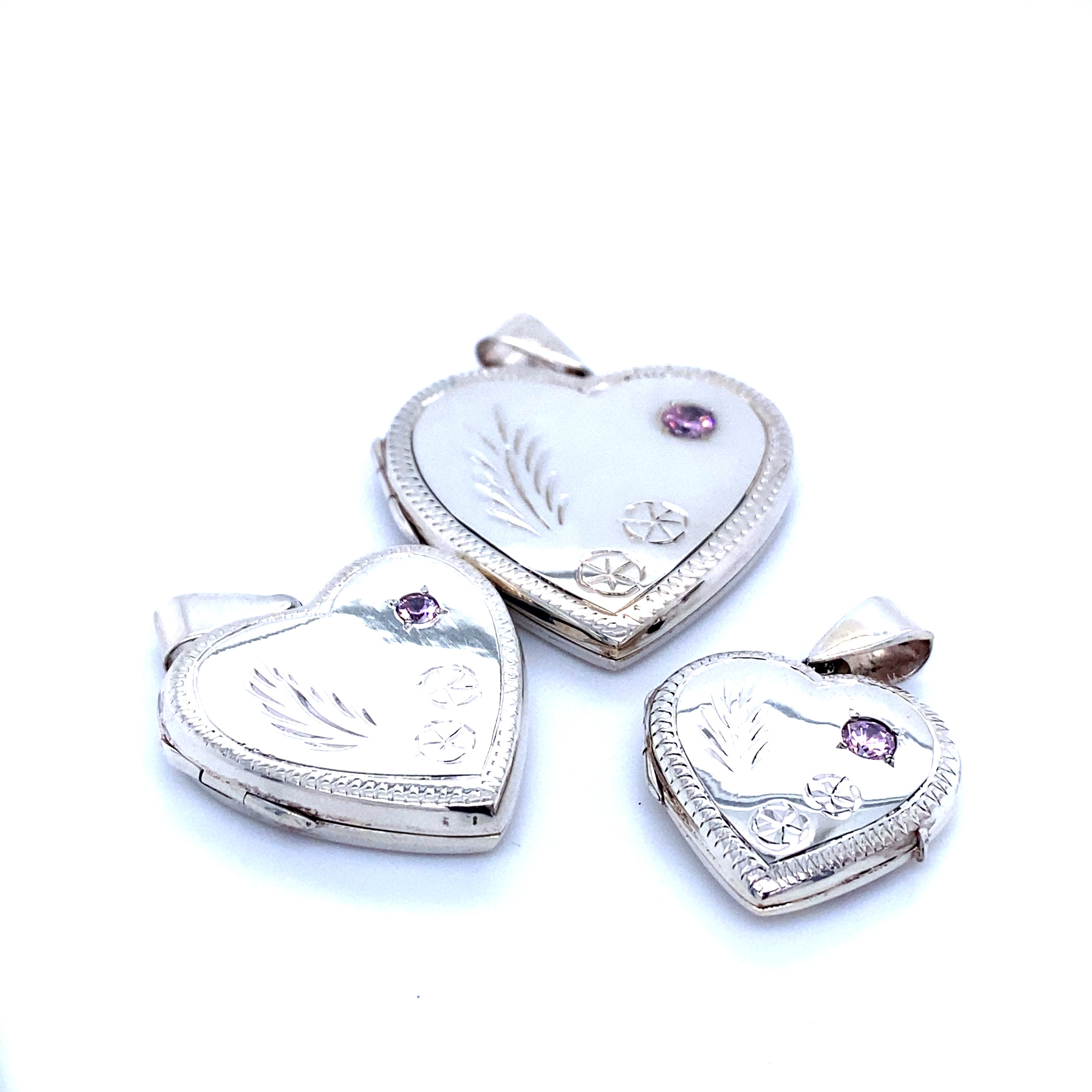 Three Heart Shaped Lockets with Stone and lacy Etching.