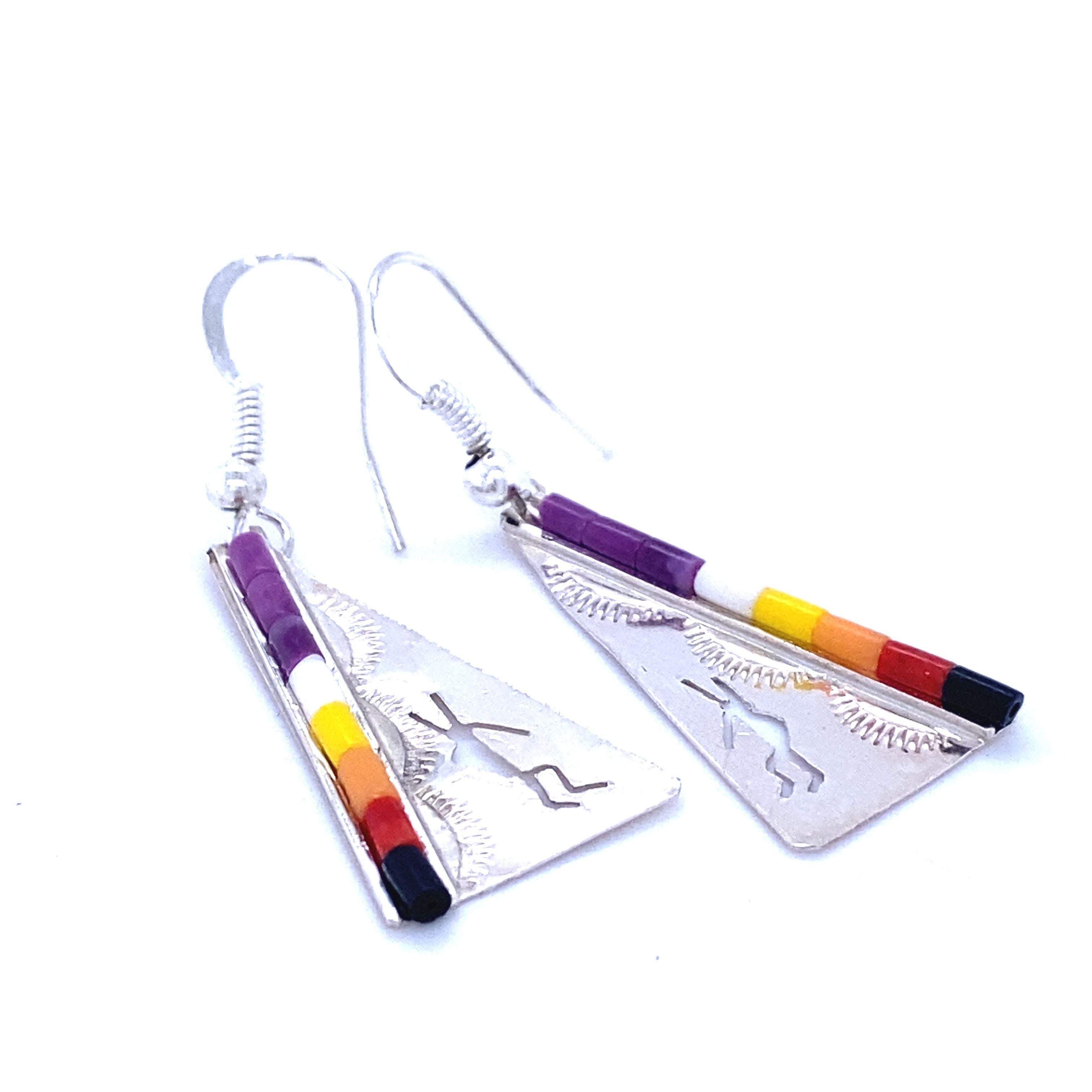 A pair of Super Silver Native Triangular Earrings adorned with colorful southwest designs featuring Dancing Kokopelli.